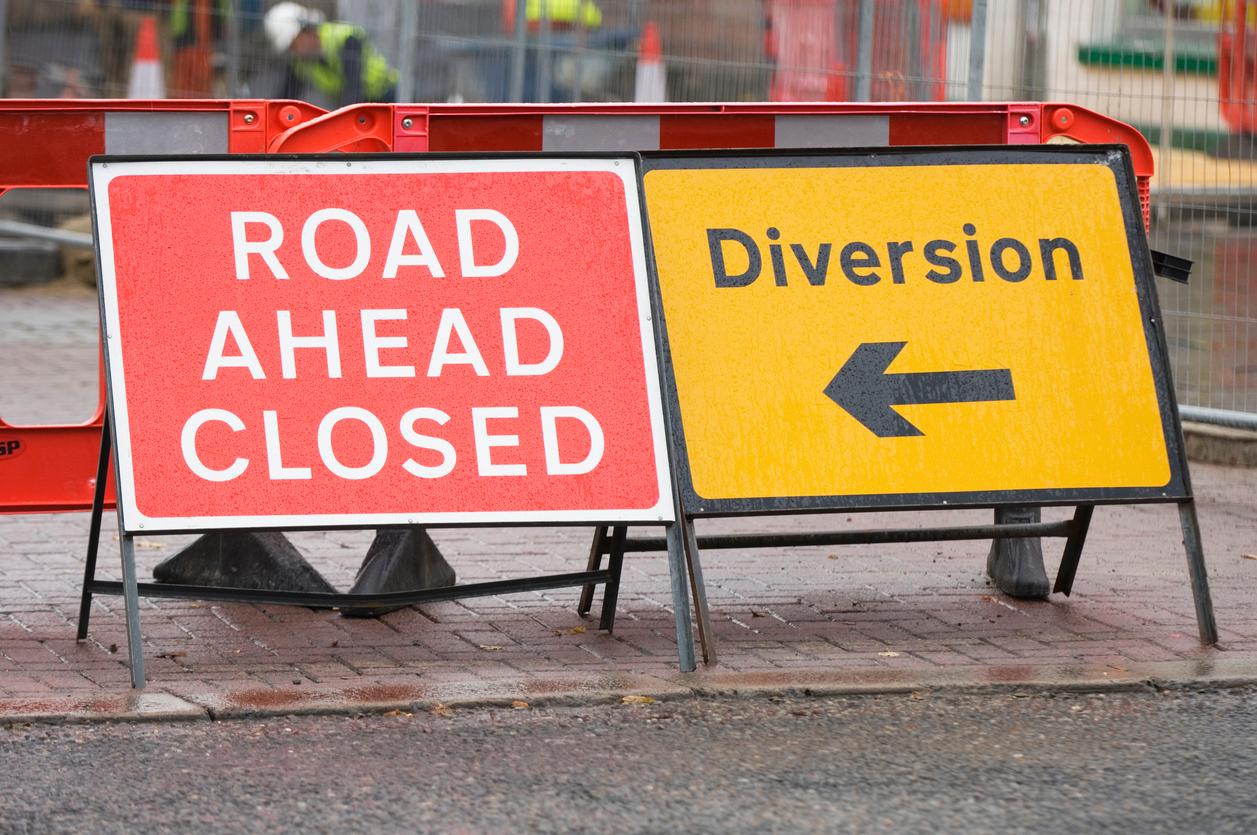 Two signs reading 'road ahead closed' and diversion'