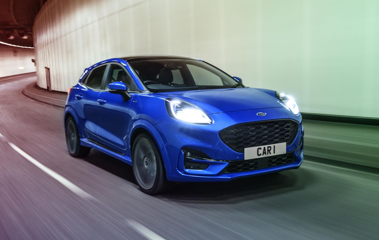 a dark blue ford puma driving through a tunnel