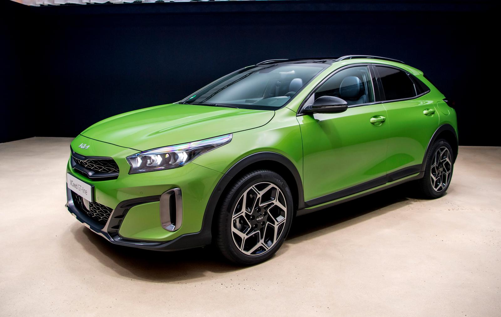 A lime-green KIA XCeed facing left