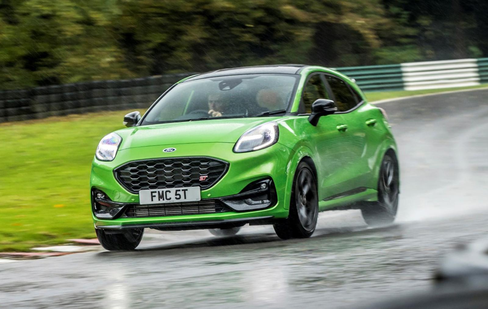 a bright green ford puma driving on a wet track