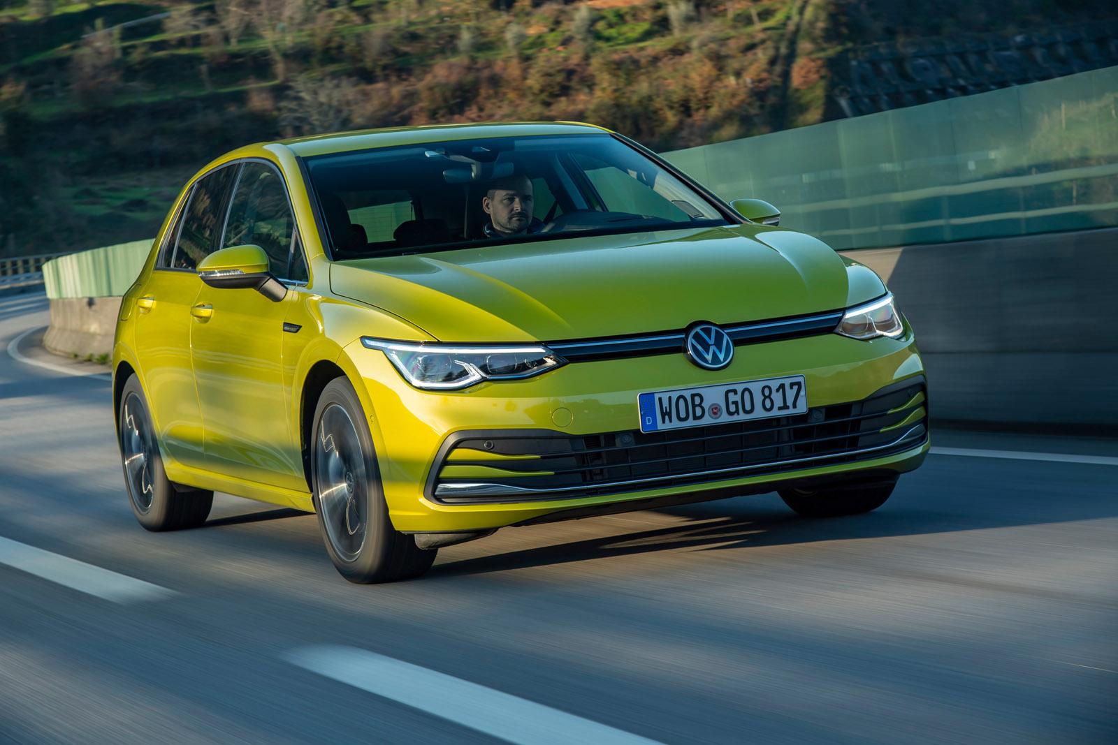 a yellow VW Golf MK8 driving on a road
