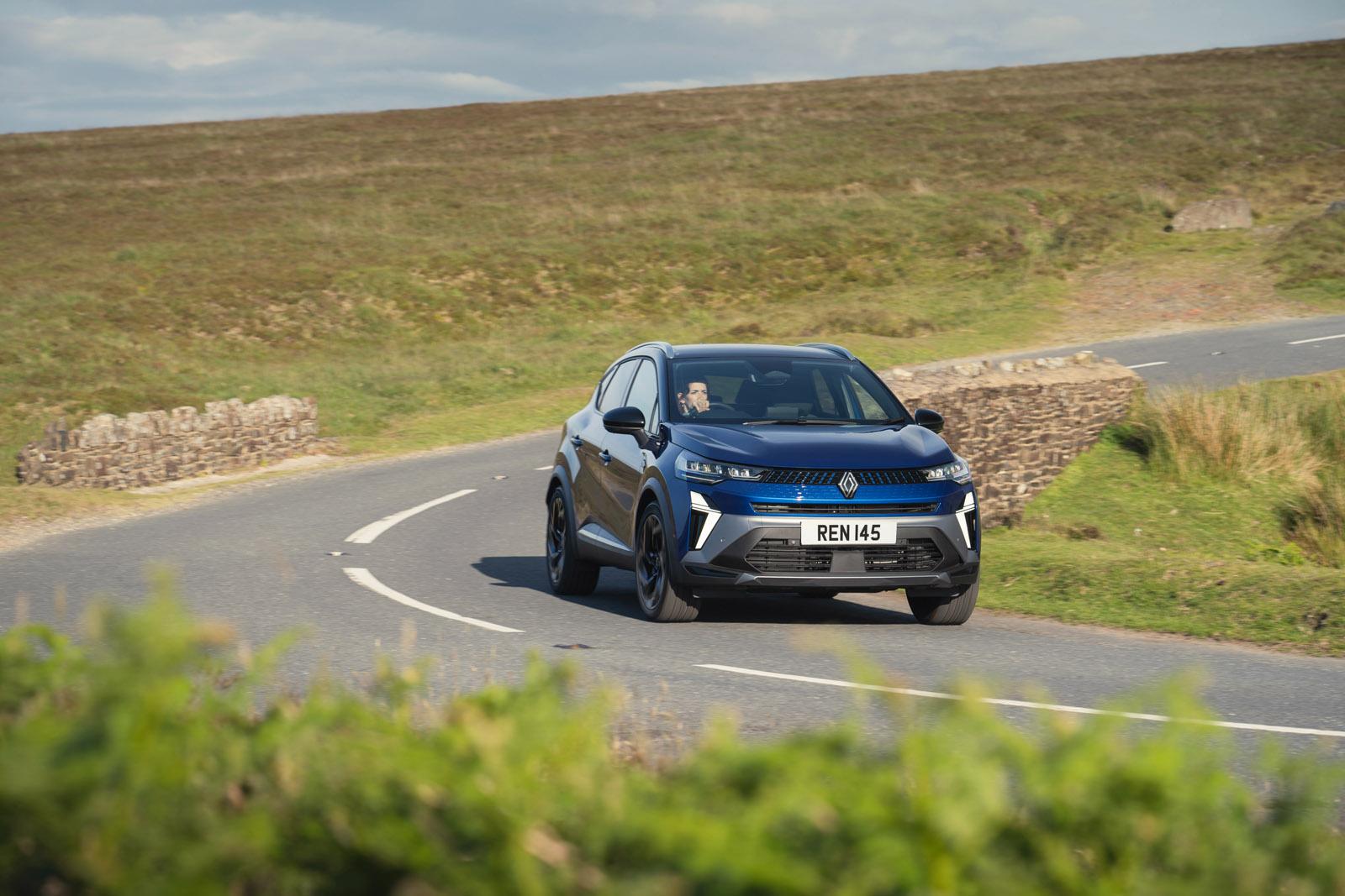 a blue renault captur driving