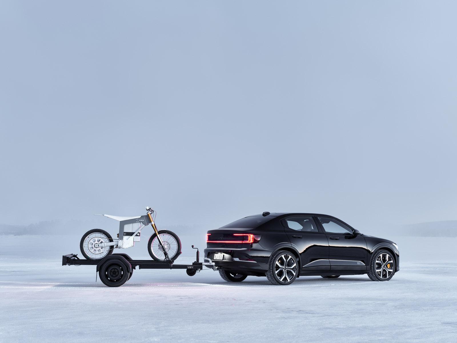 a black polestar 2 towing a motorbike