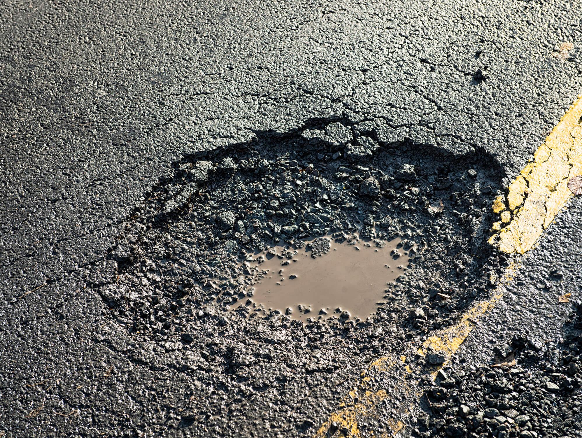 A pothole filled with water