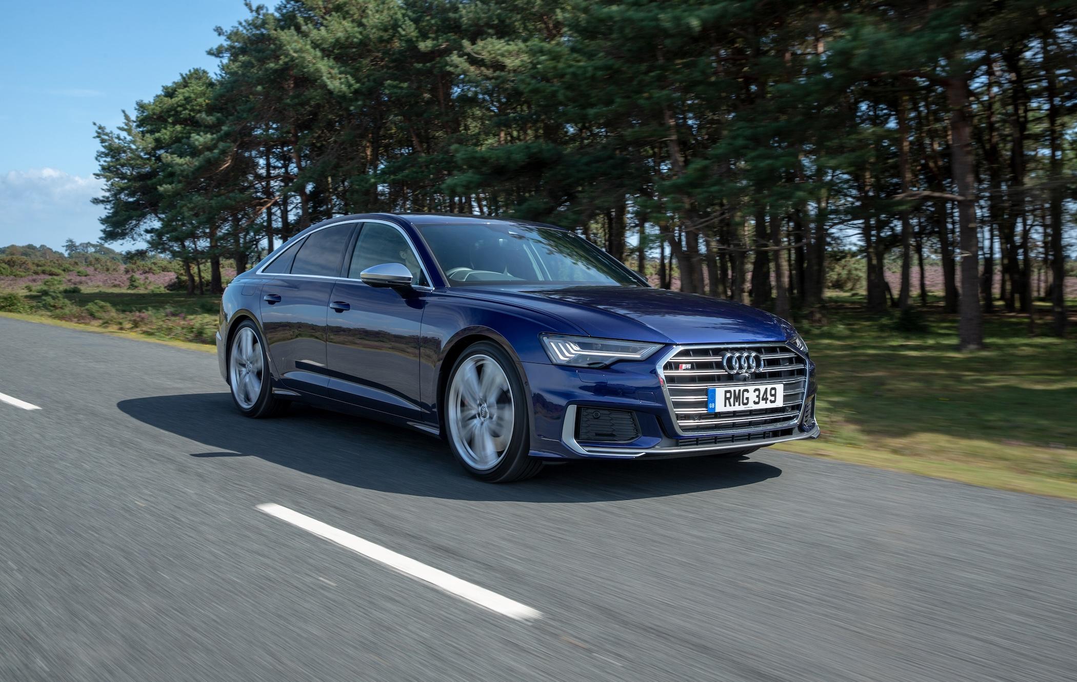 Dark blue Audi S6 Saloon driving on country road