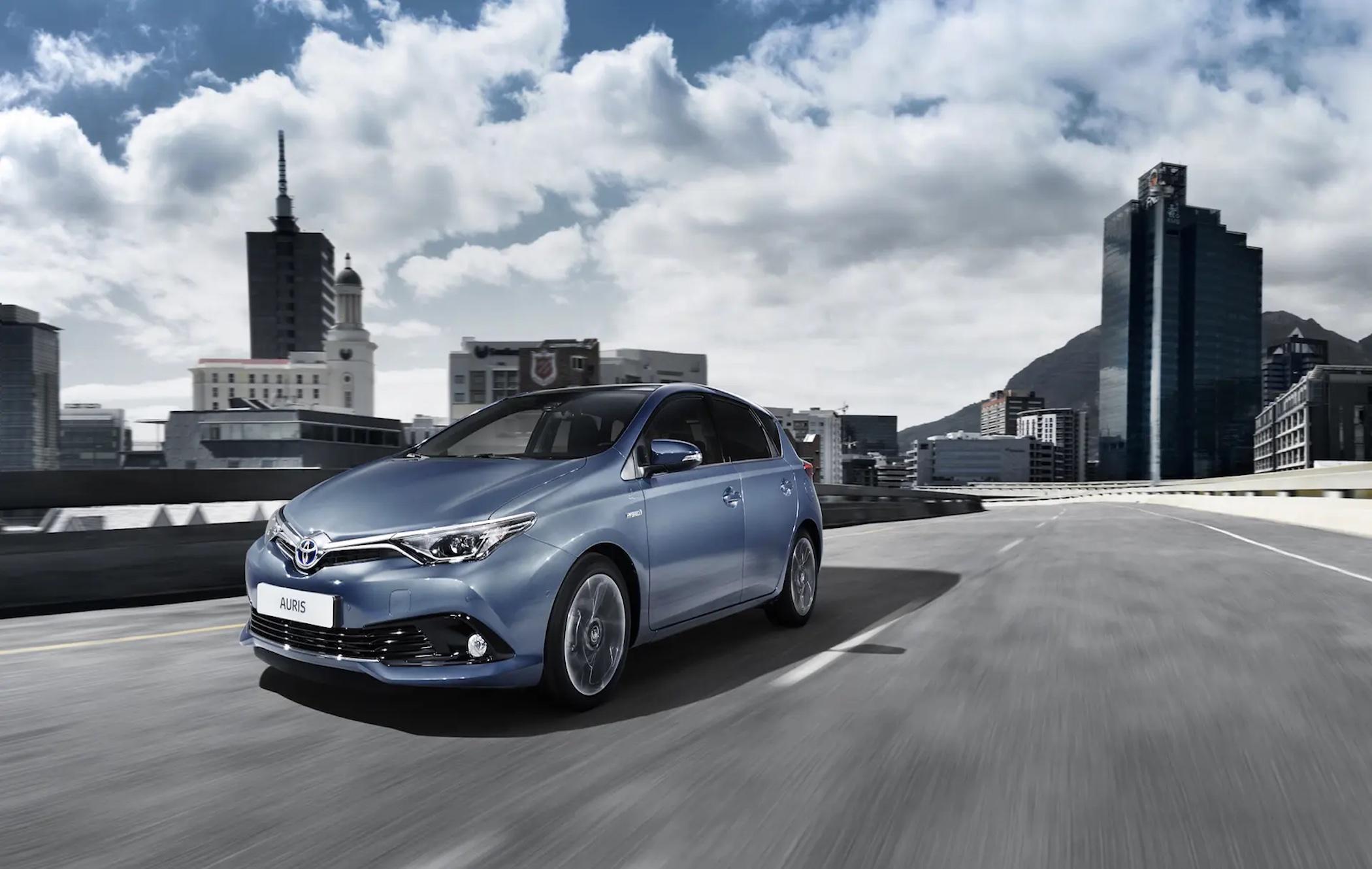 A blue Toyota Auris driving along a road