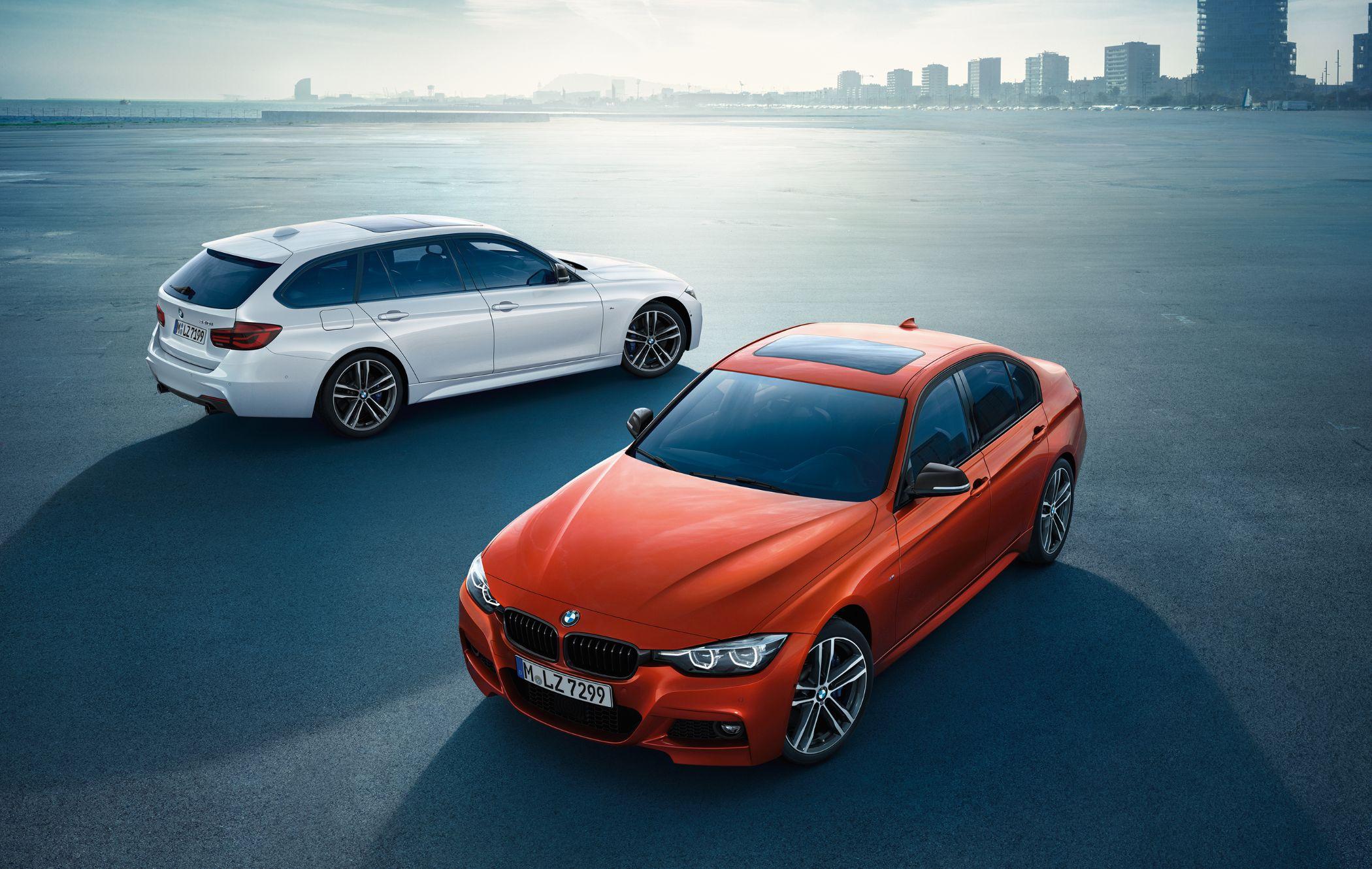 White BMW 3 Series Touring and orange BMW 3 Series in M Sport Shadow Edition trim