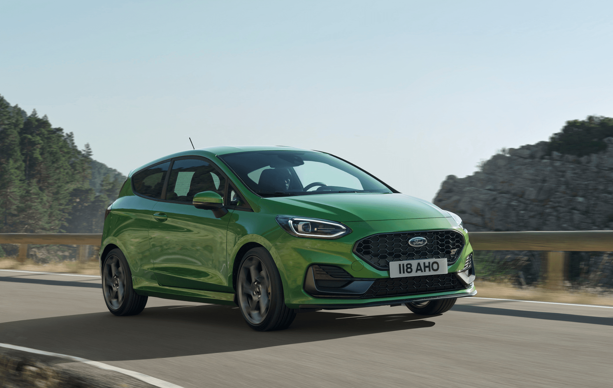 Facelifted Ford Fiesta ST in green driving on road