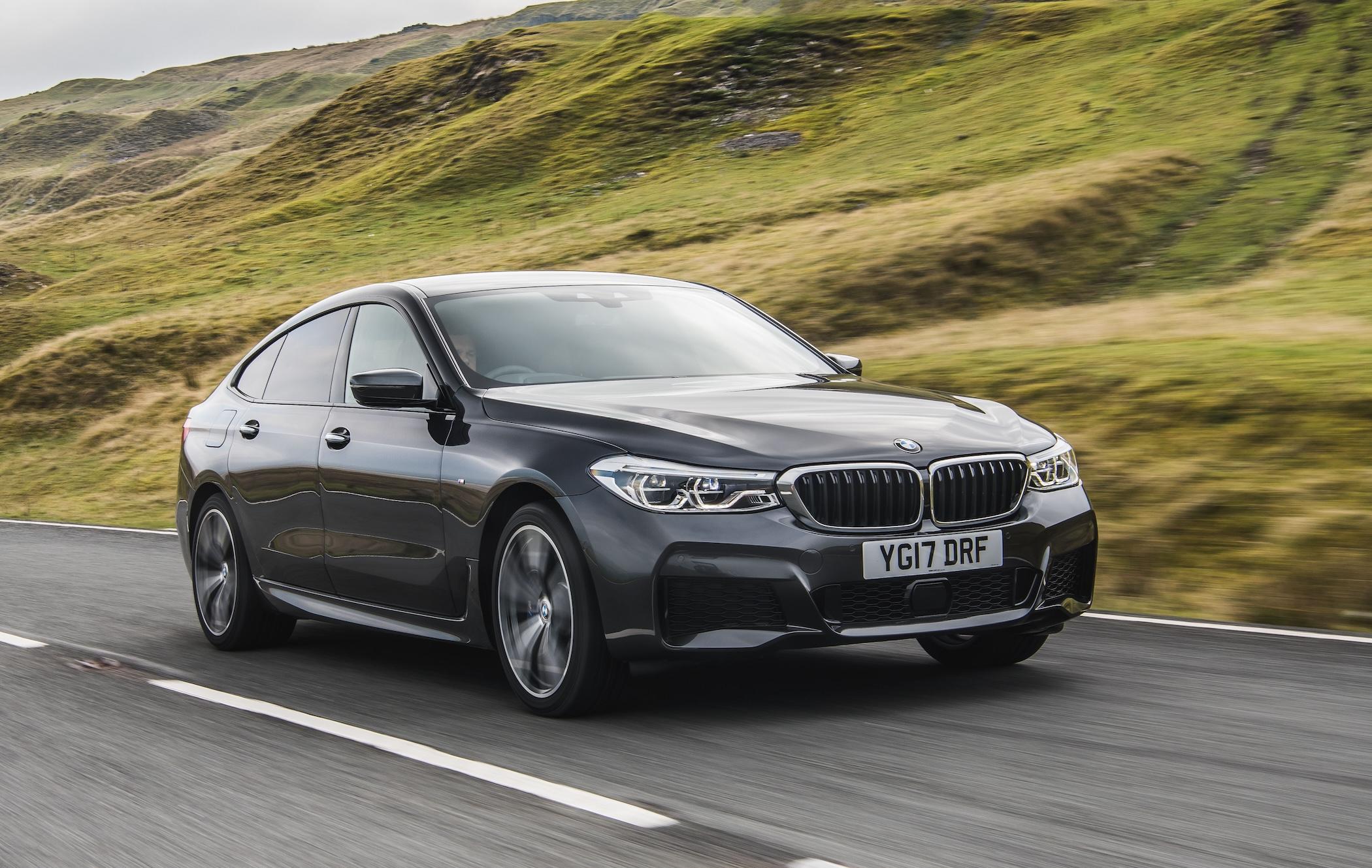 Black BMW 6 Series Gran Turismo driving along road