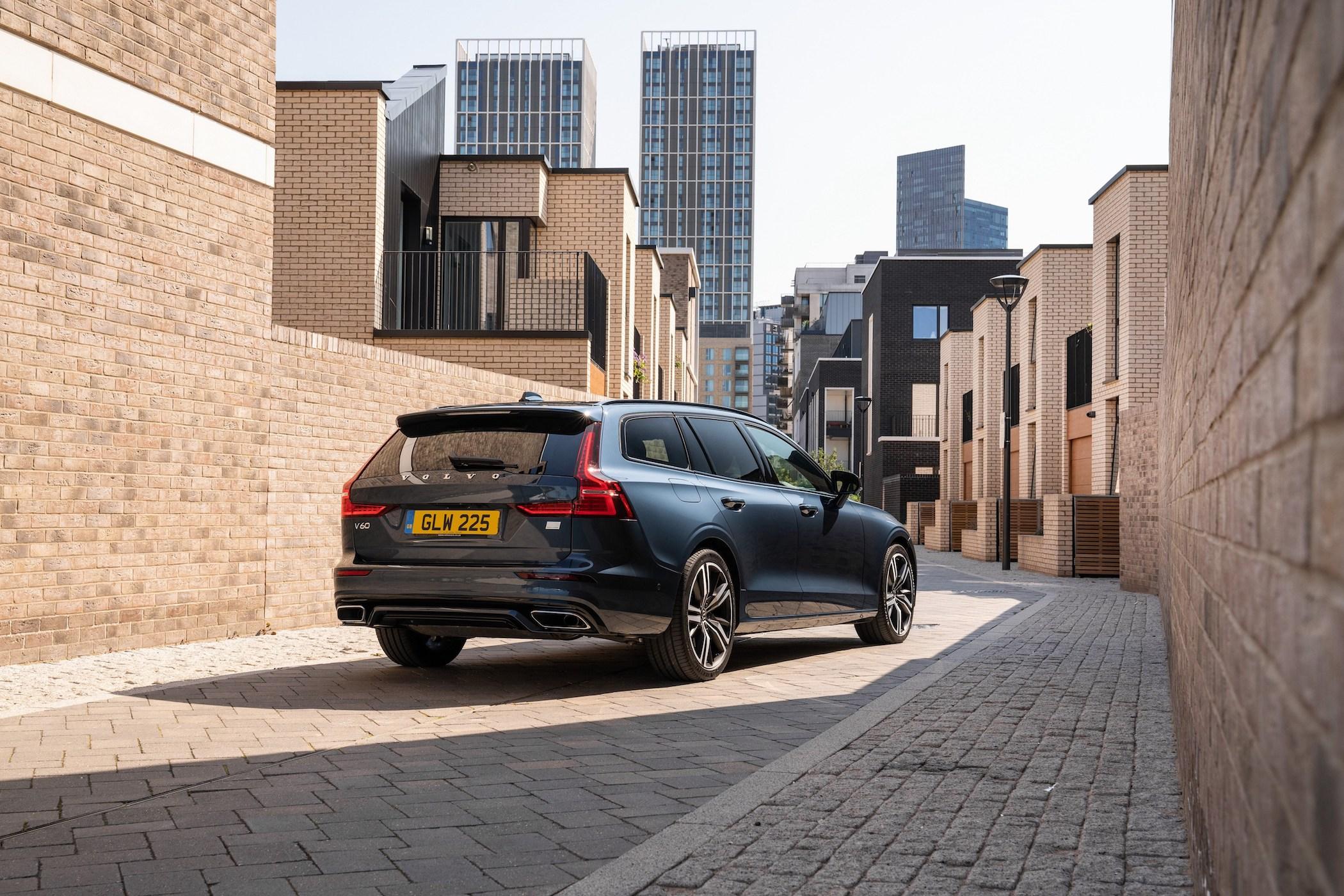 a dark blue volvo v60 estate parked among buildings in a city