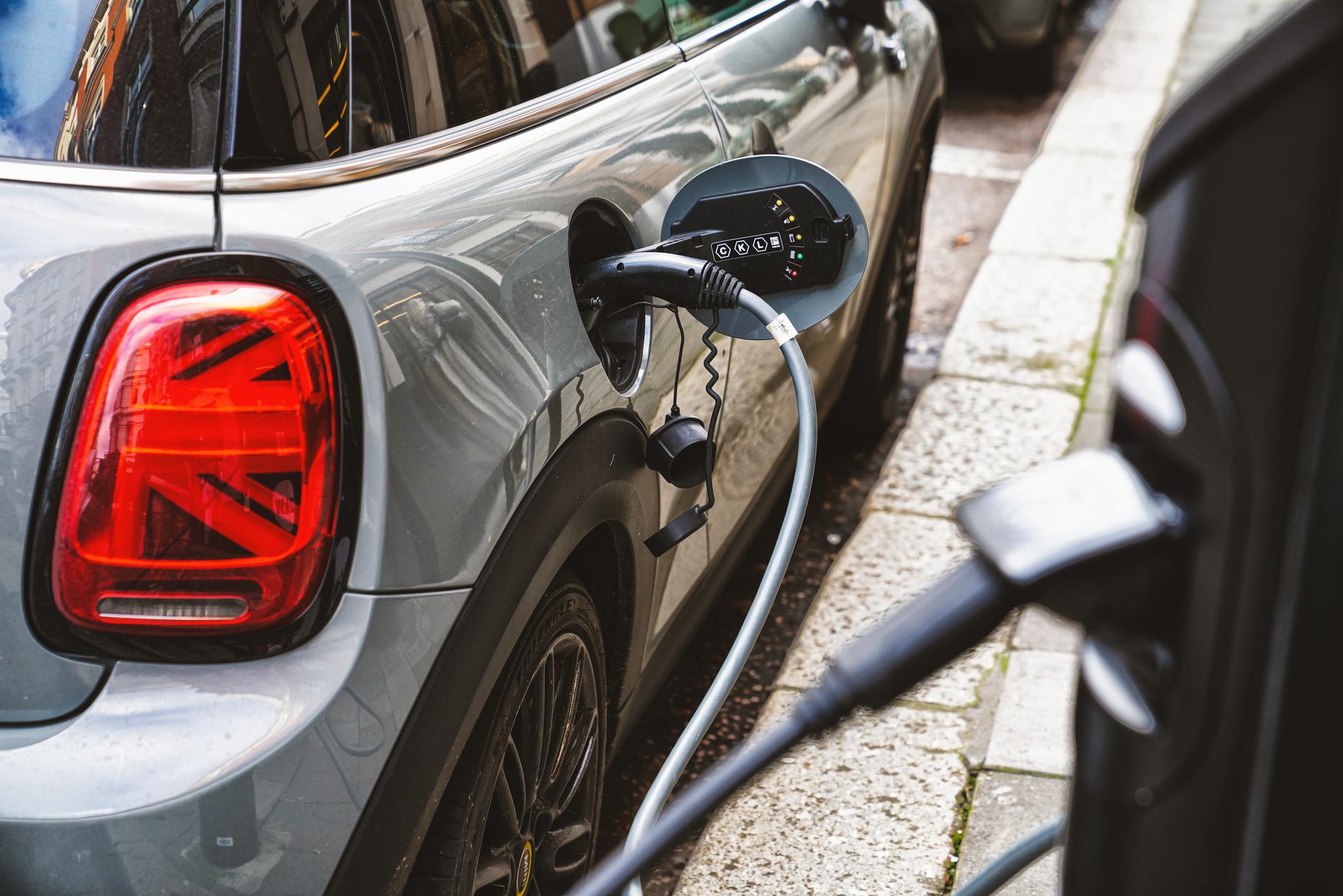 A close up of an EV charger plugged into a Mini