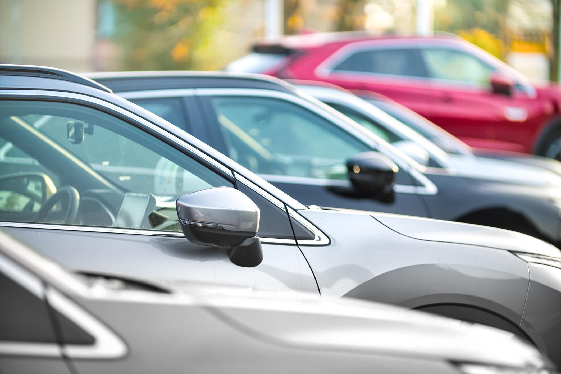 A close up photo of cars parking in a carpark