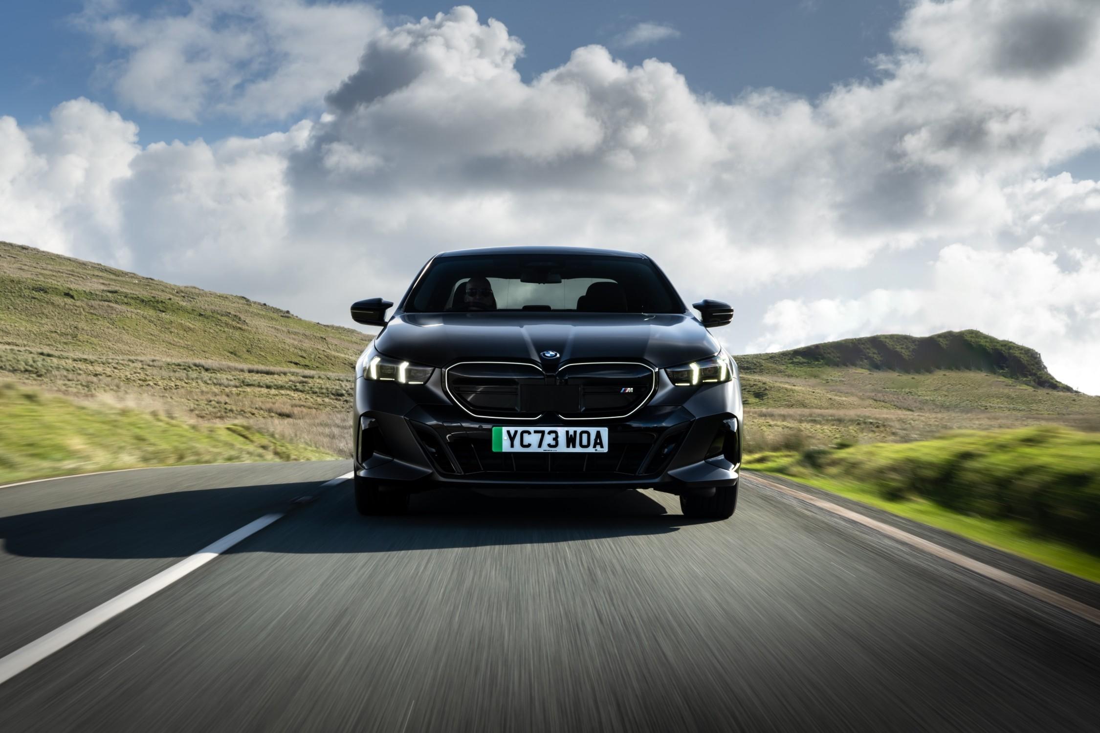 a black bmw i5 m60 driving on a country road in the UK