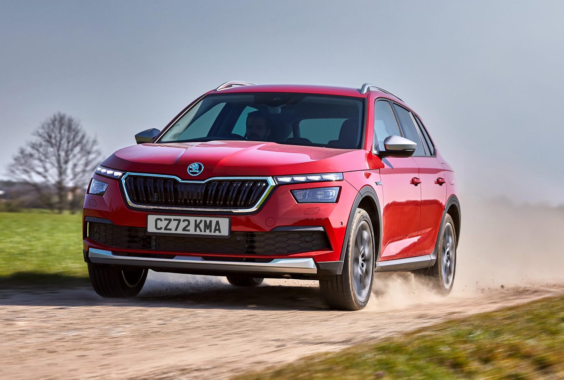 a red Skoda Kamiq off-roading on sand