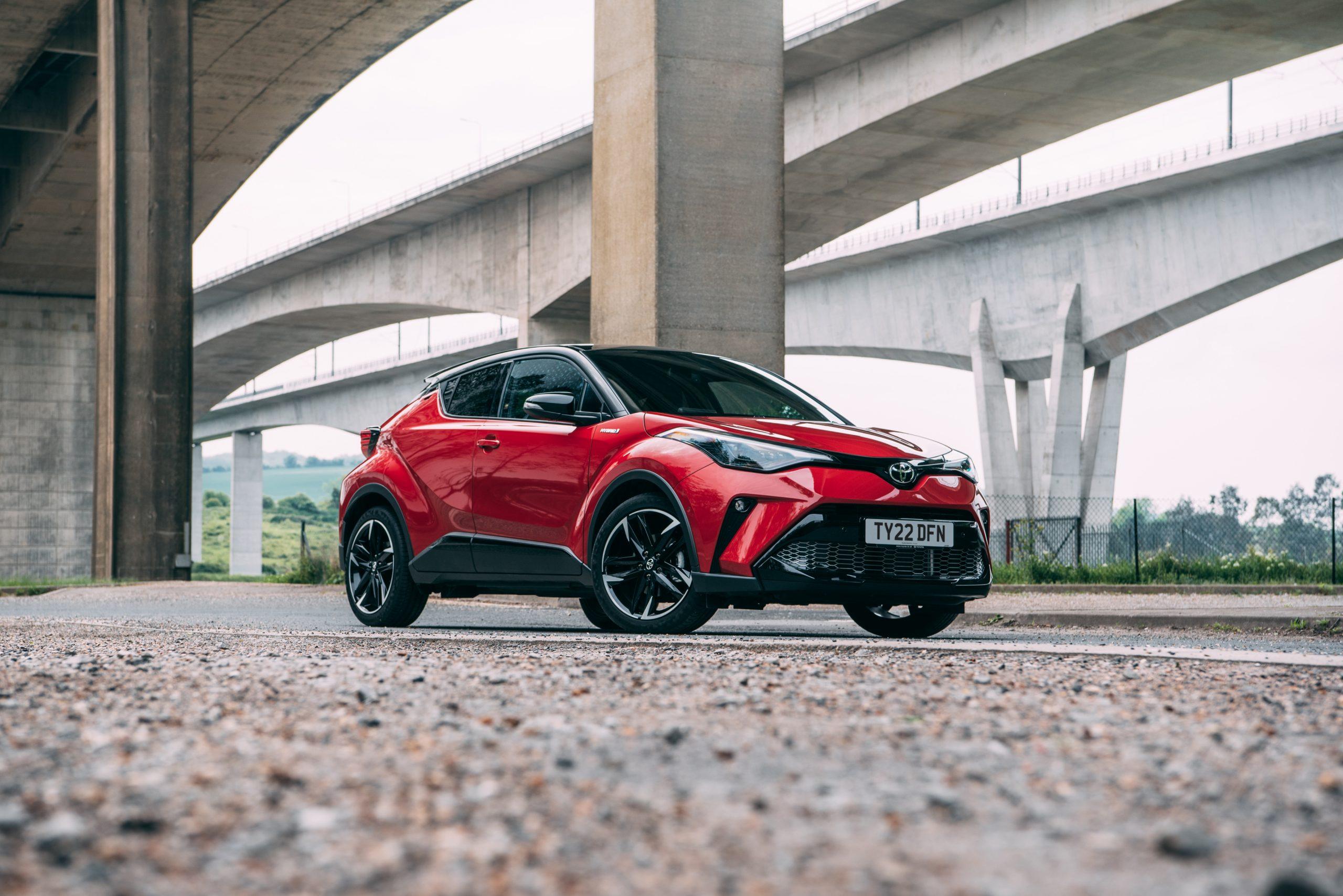 a 2022 toyota c-hr parked on a road under a bridge