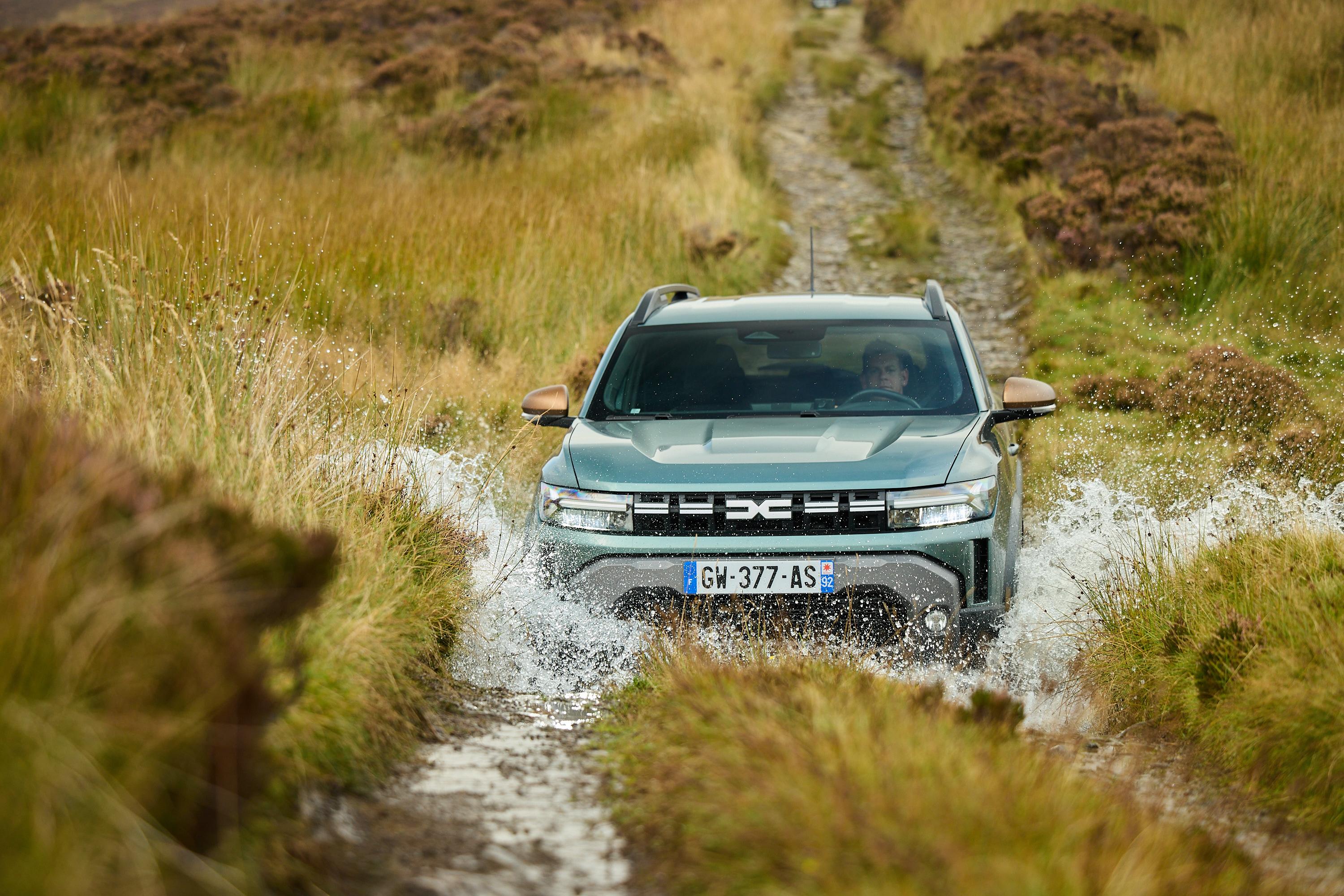 a green dacia duster off road