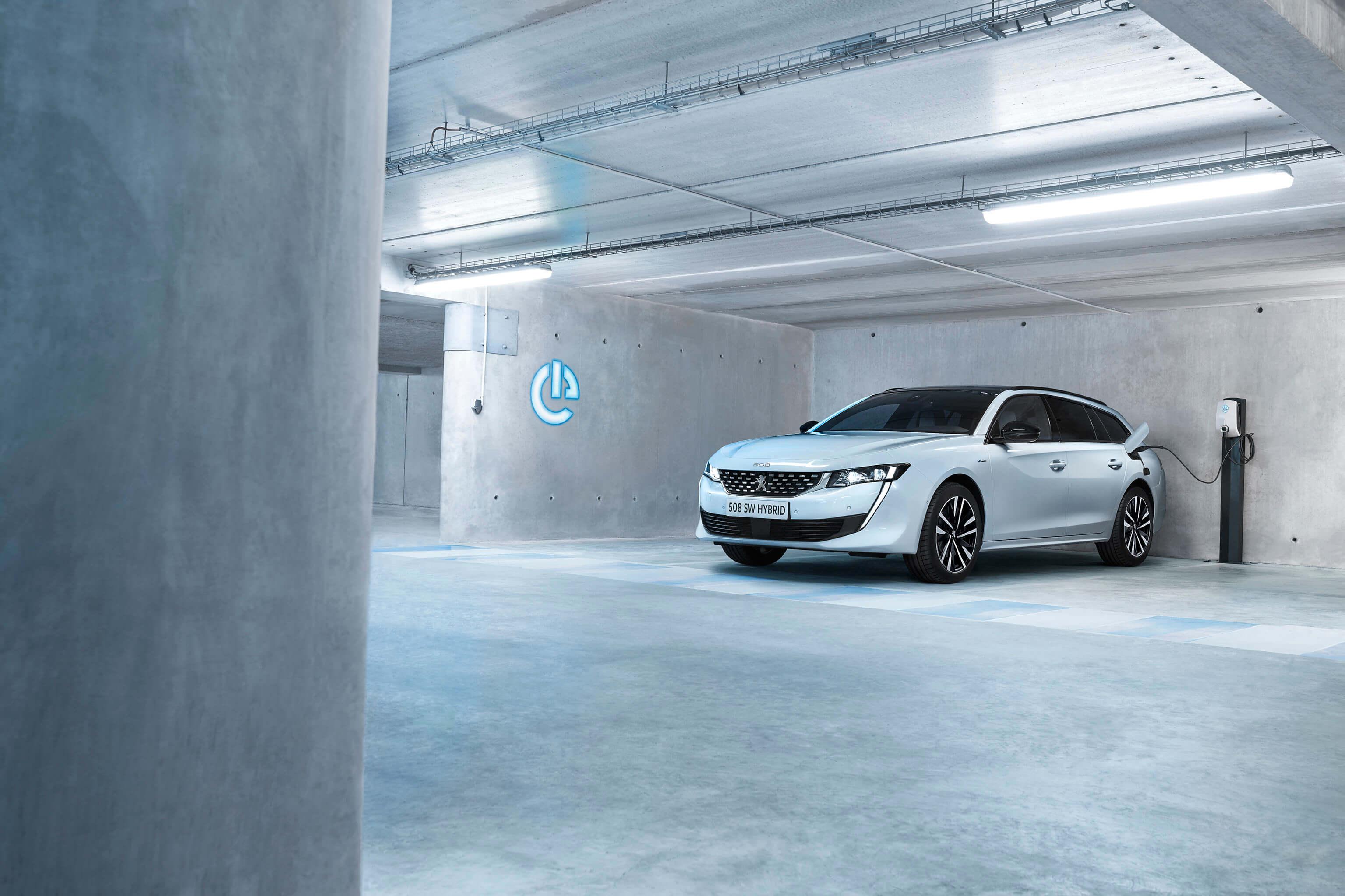 A Peugeot 508 hybrid plugged in charging