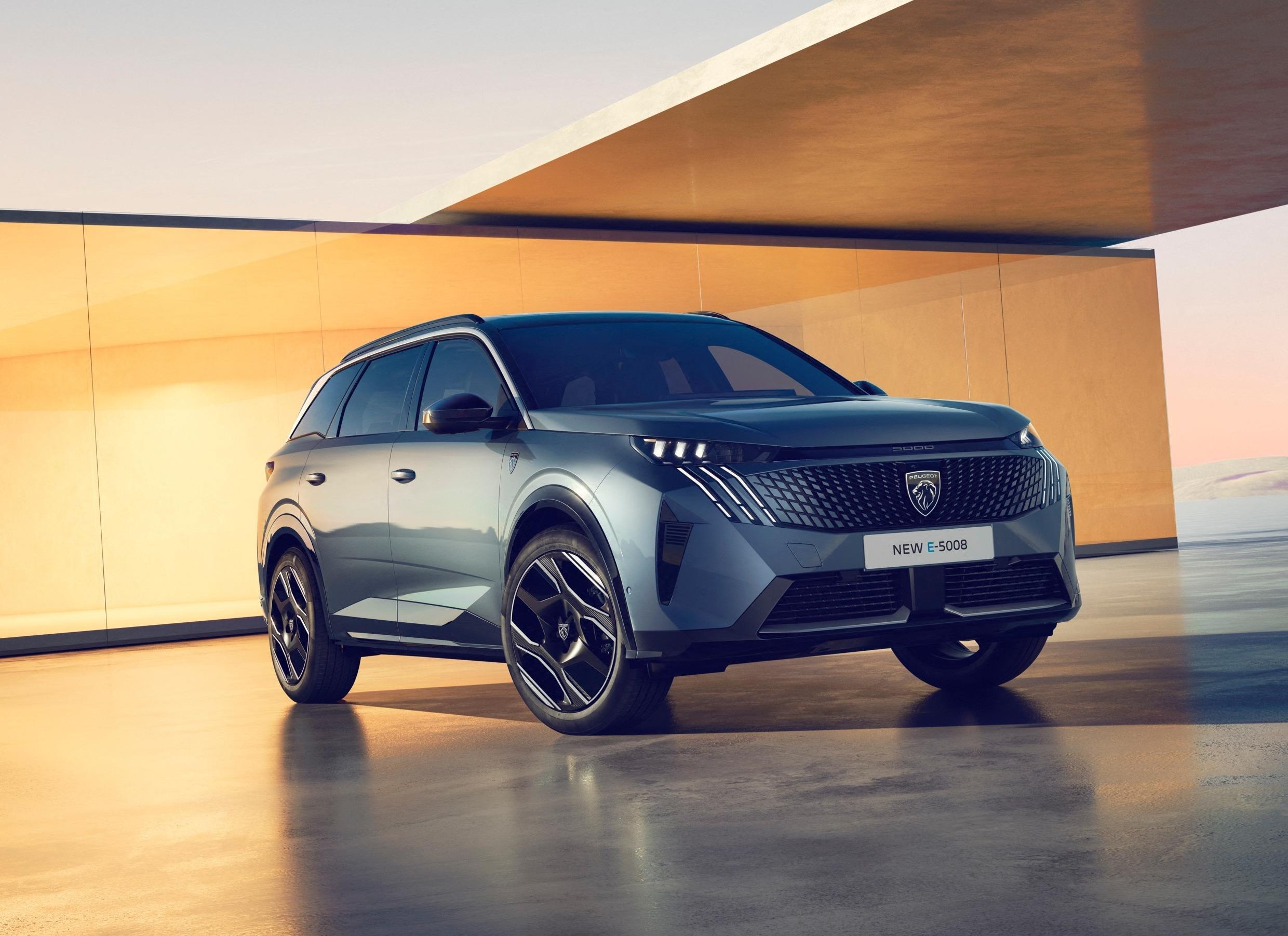 A grey/blue peugeot e-5008 parked in a futuristic setting