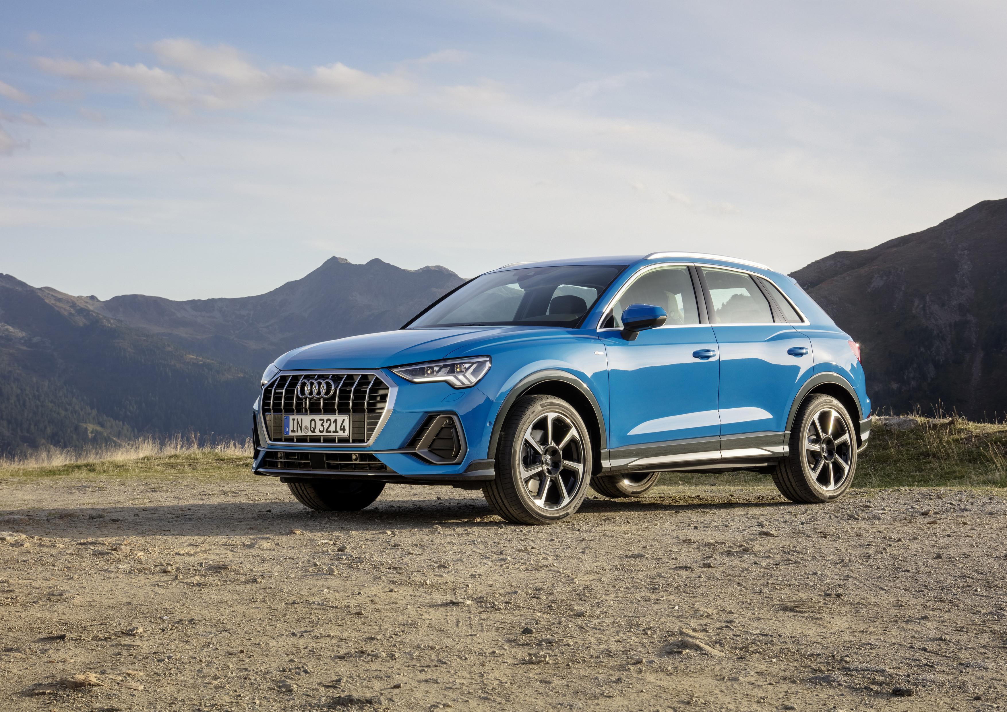 A blue Audi Q3 photographed from a side angle