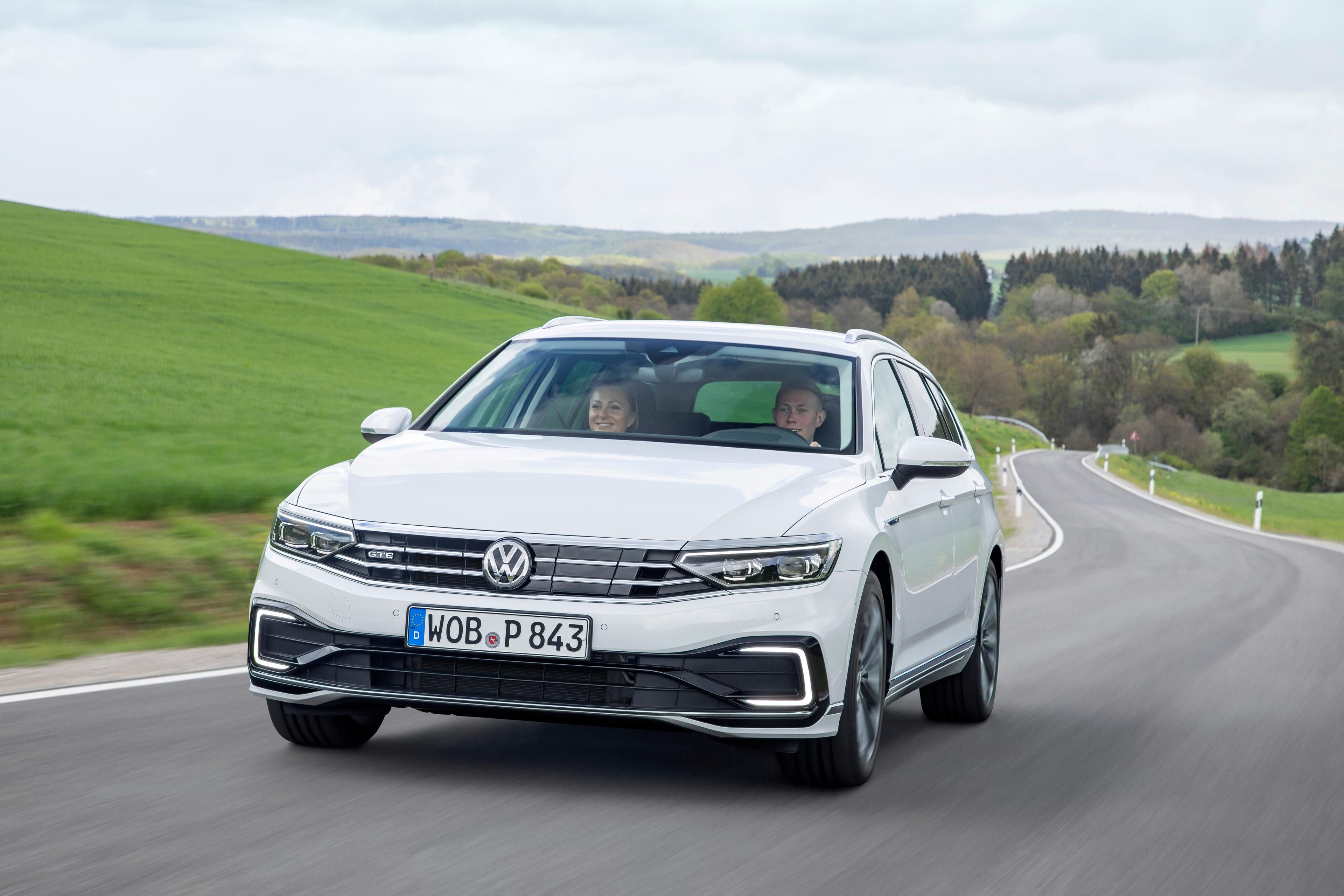 A white Passat GTE driving on a winding road. 