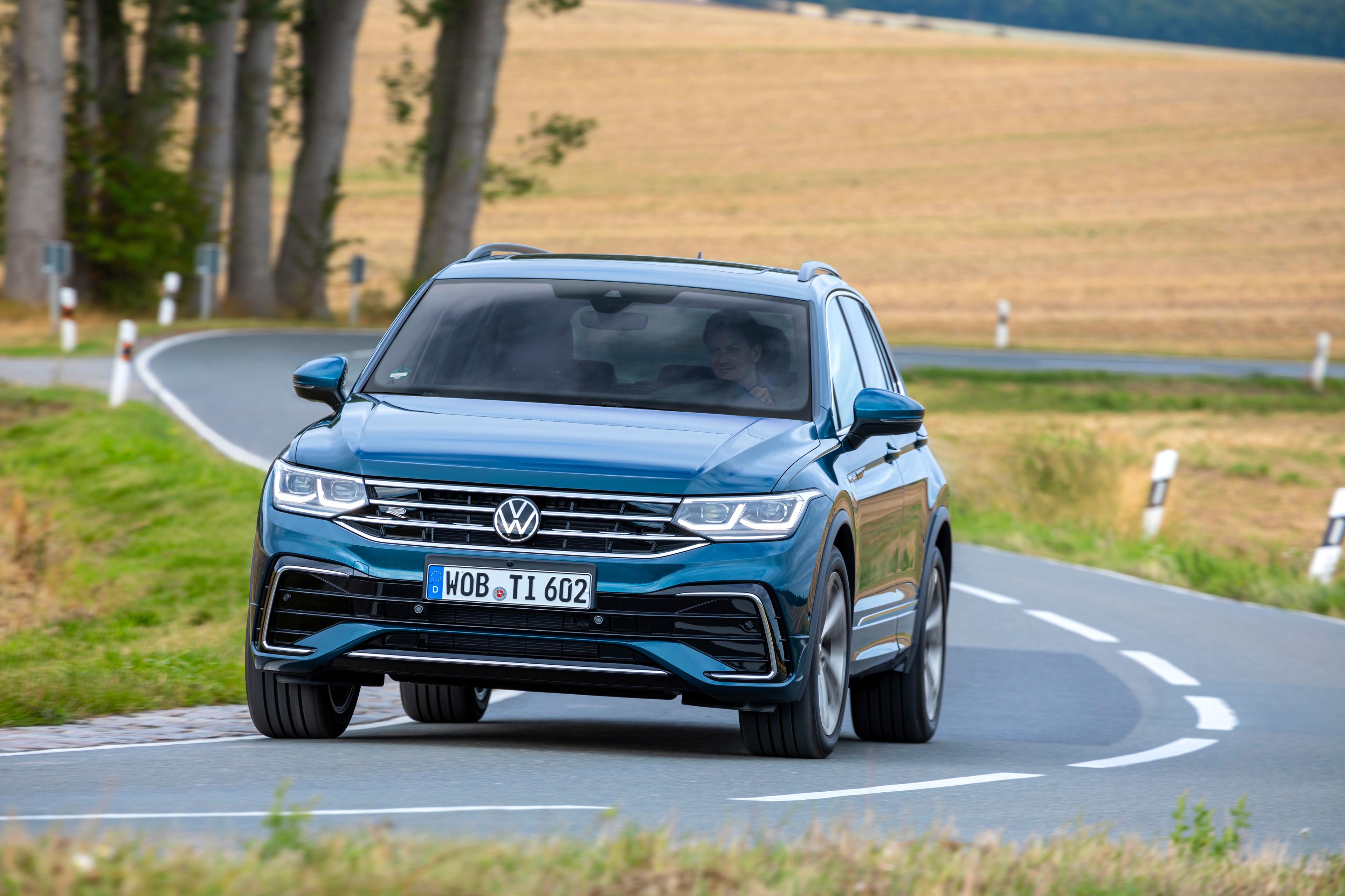 a blue Volkswagen Tiguan driving on a country road in Germany