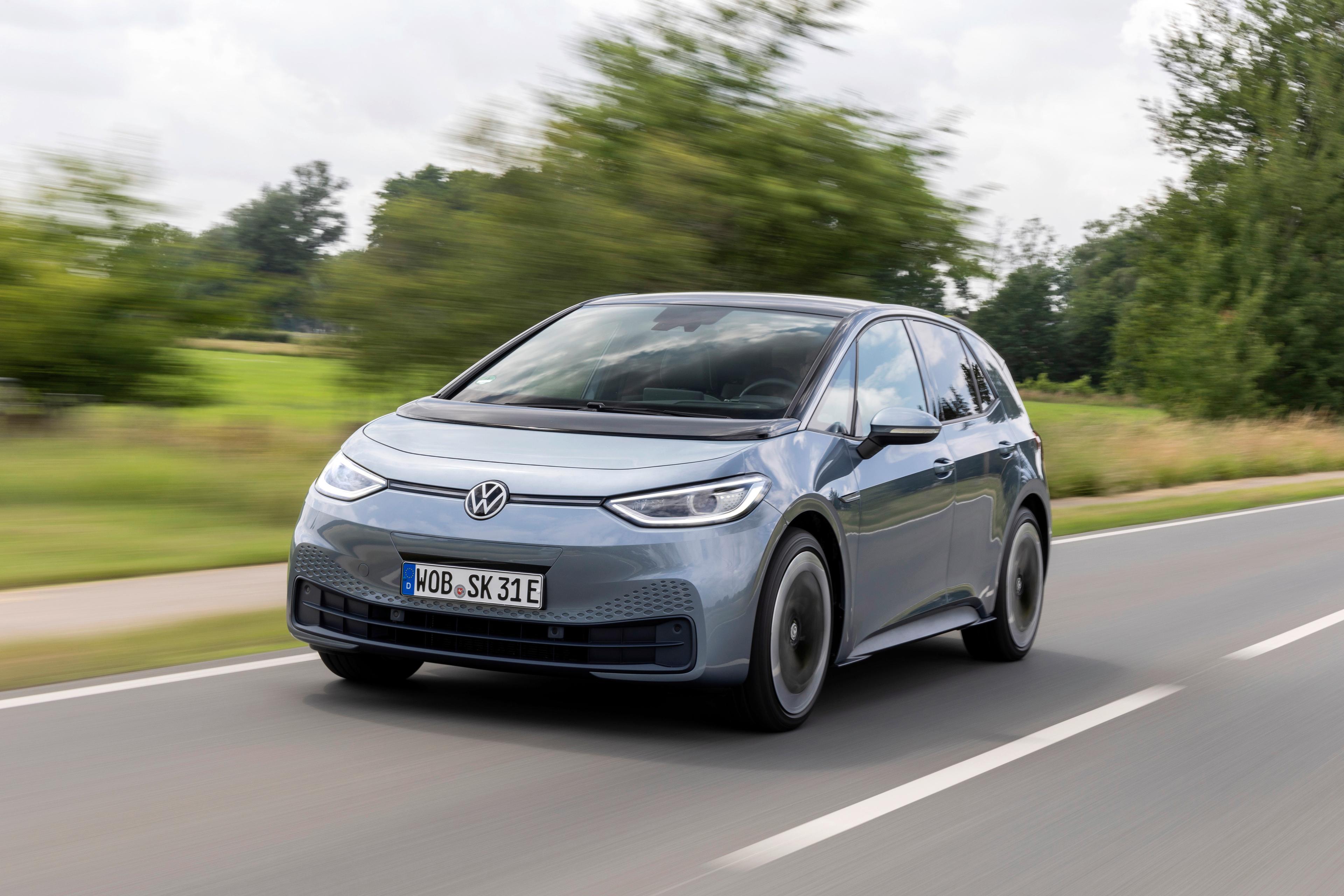 a grey volkswagen ID.3 driving on a countryside road