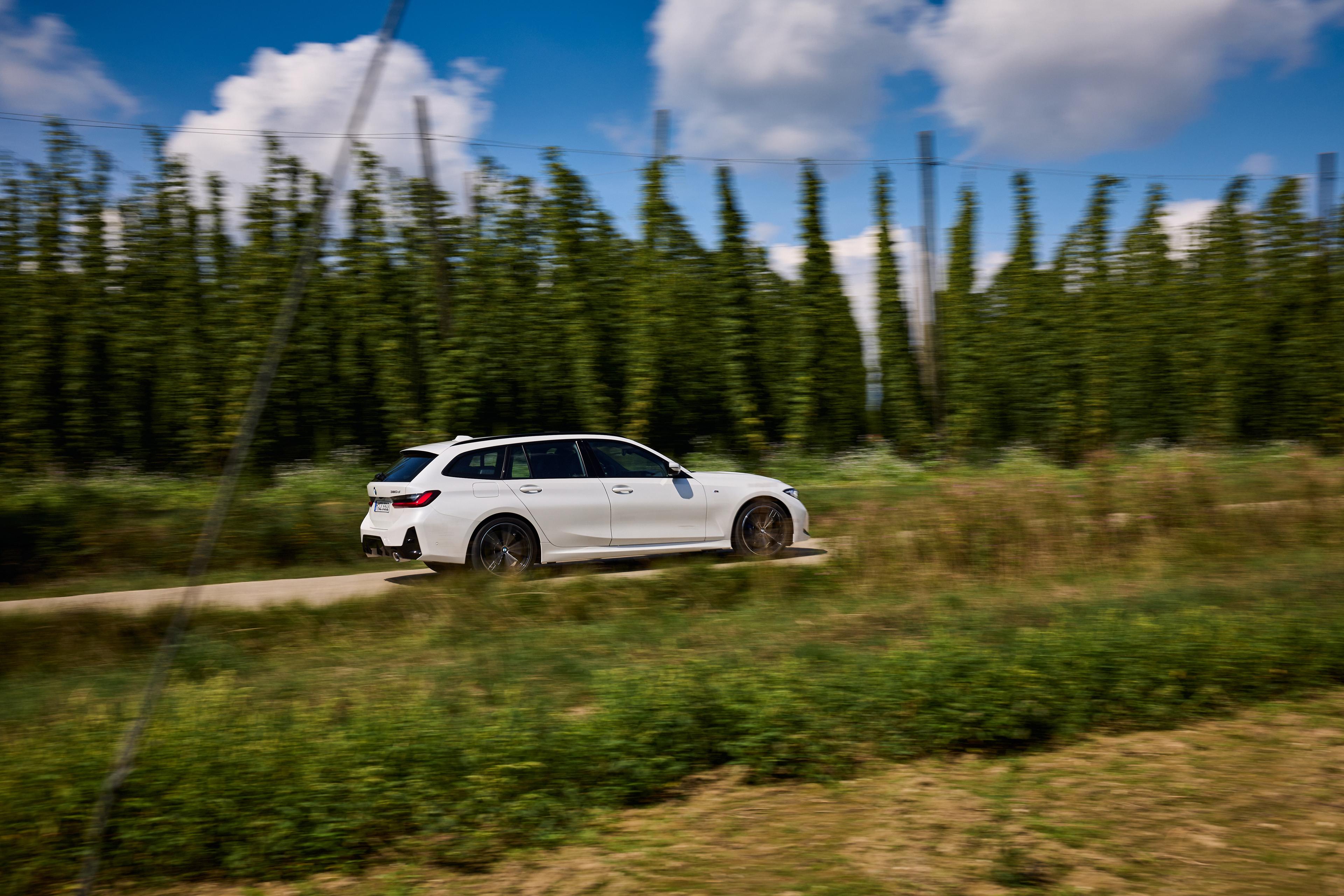 A BMW 3 Series Touring driving on a country road