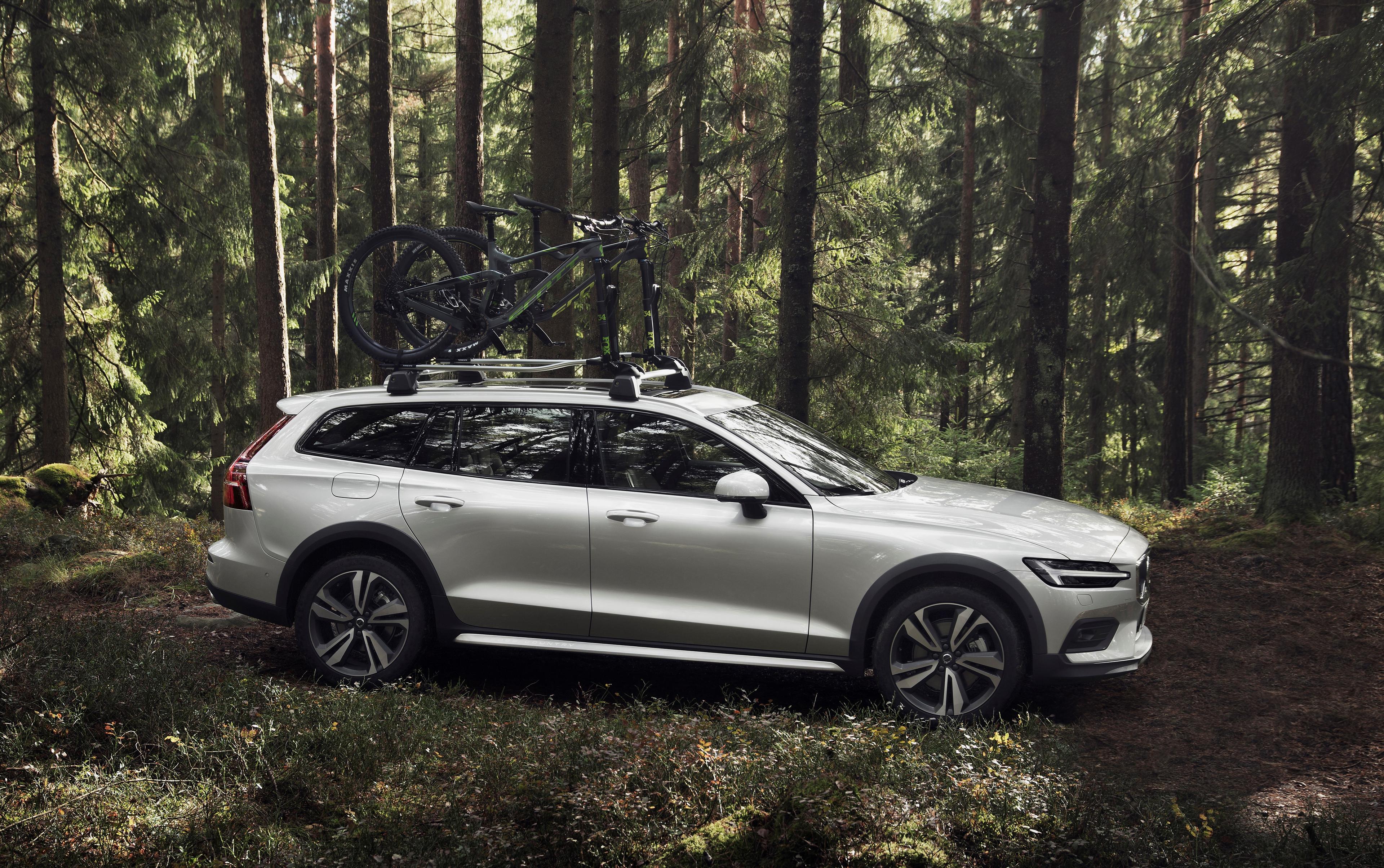 A silver Volvo V60 Cross Country among trees