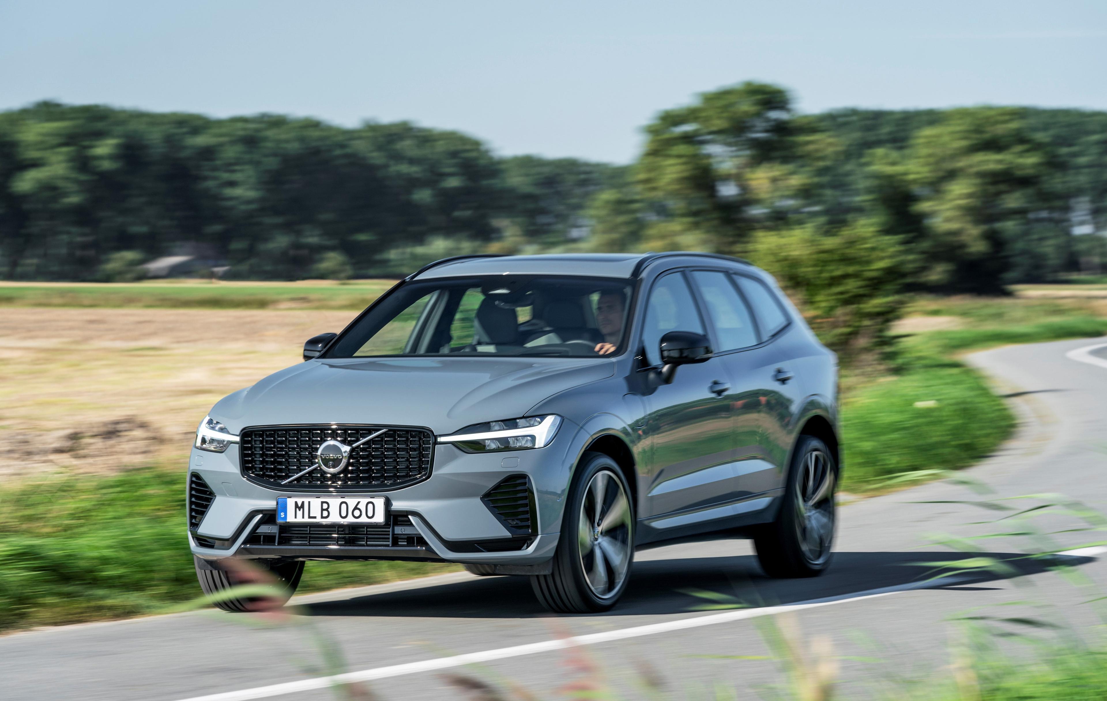 a grey Volvo xc60 driving down a country road