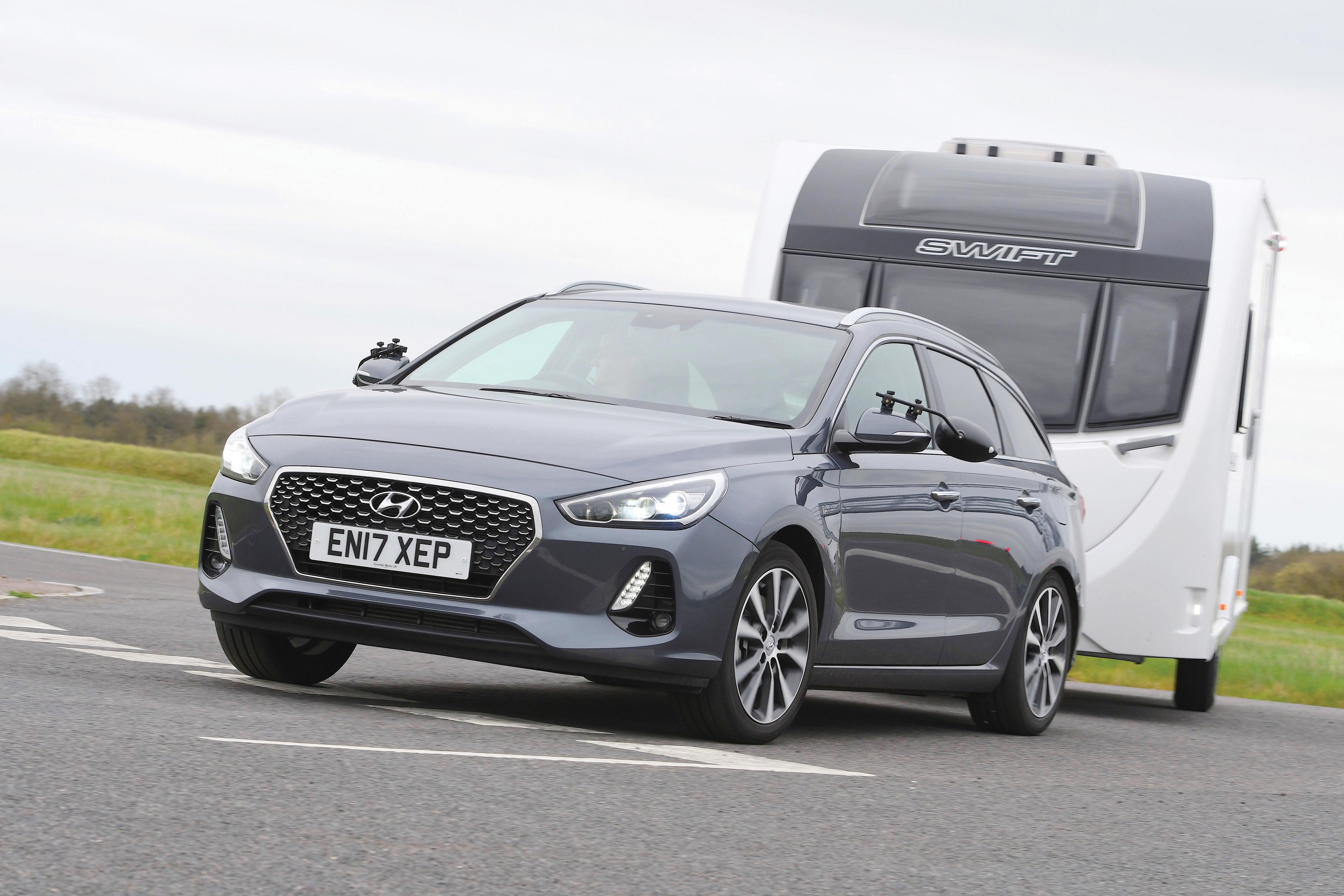 A grey Hyundai i30 Tourer pulling a caravan