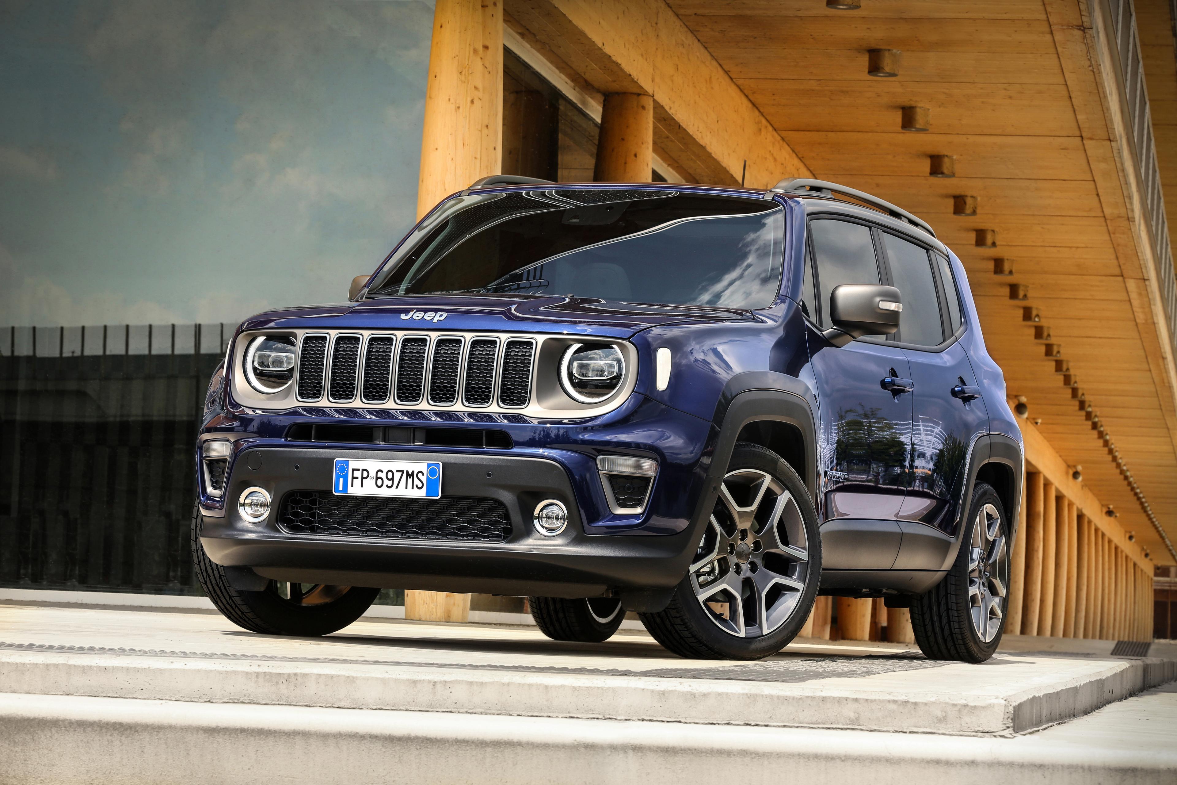 a dark blue Jeep Renegade parked under a concrete building