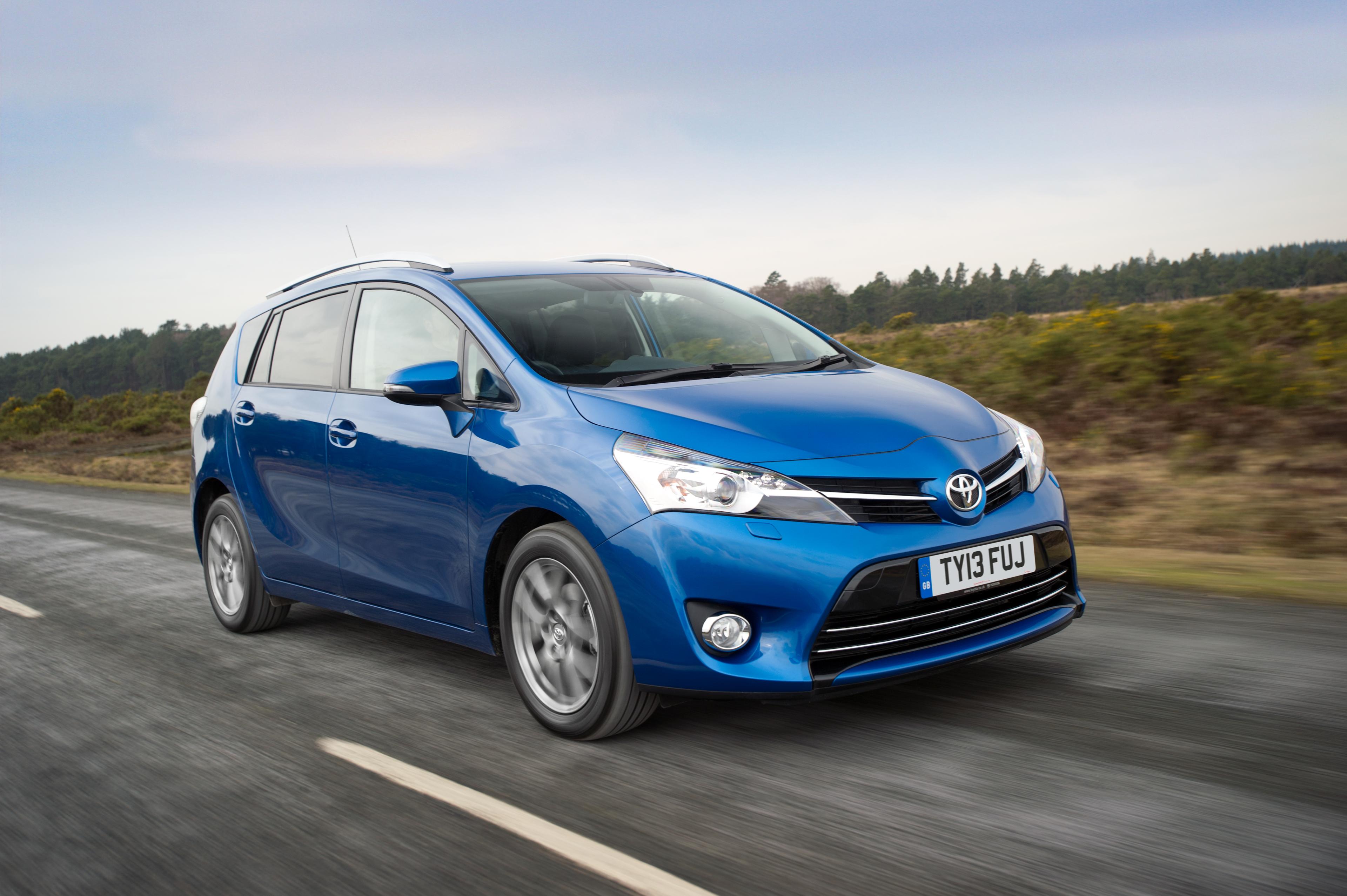 A blue Toyota Verso driving down a road