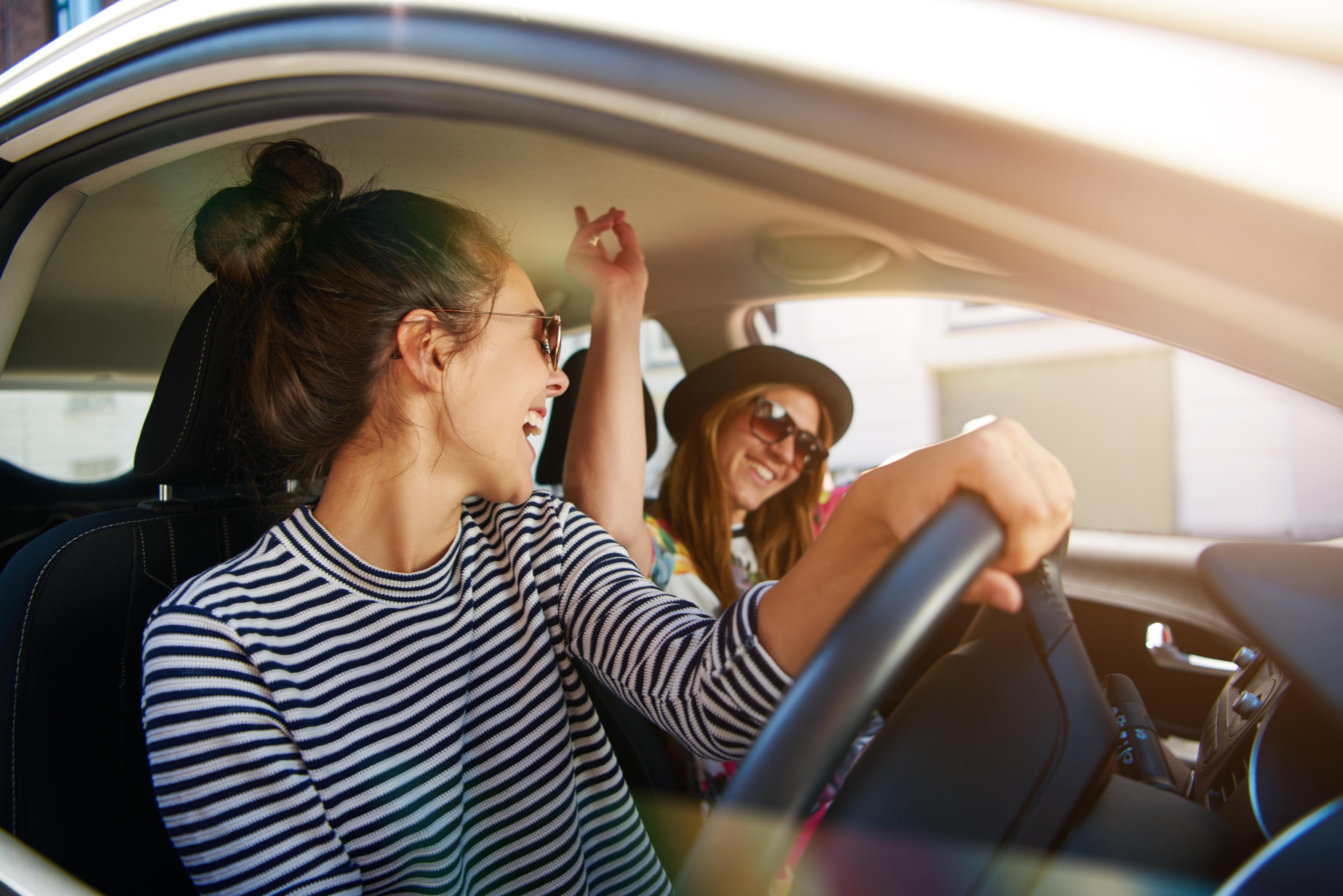 Two women partying in a car 