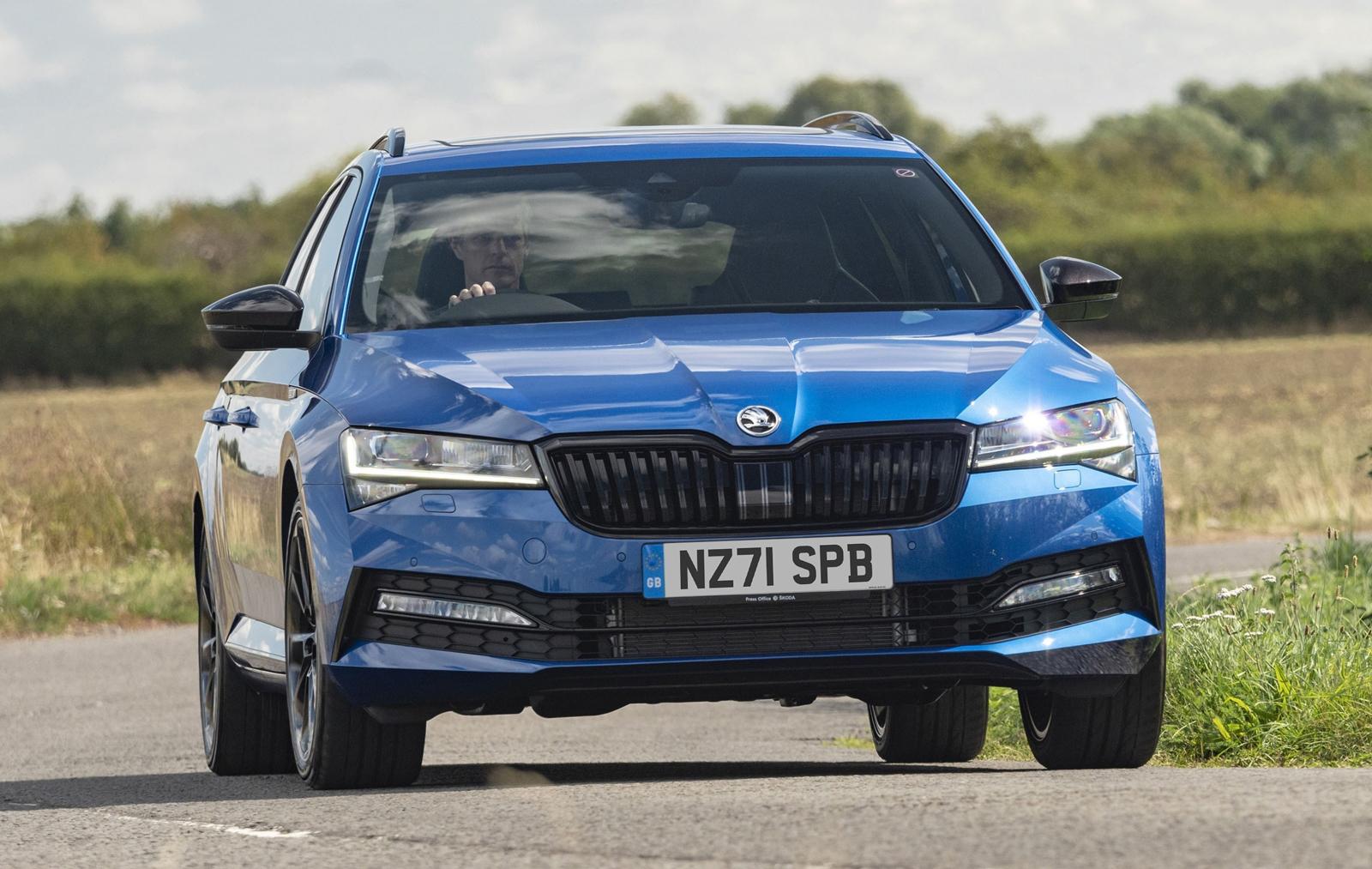 blue Skoda Superb Estate driving on a country road