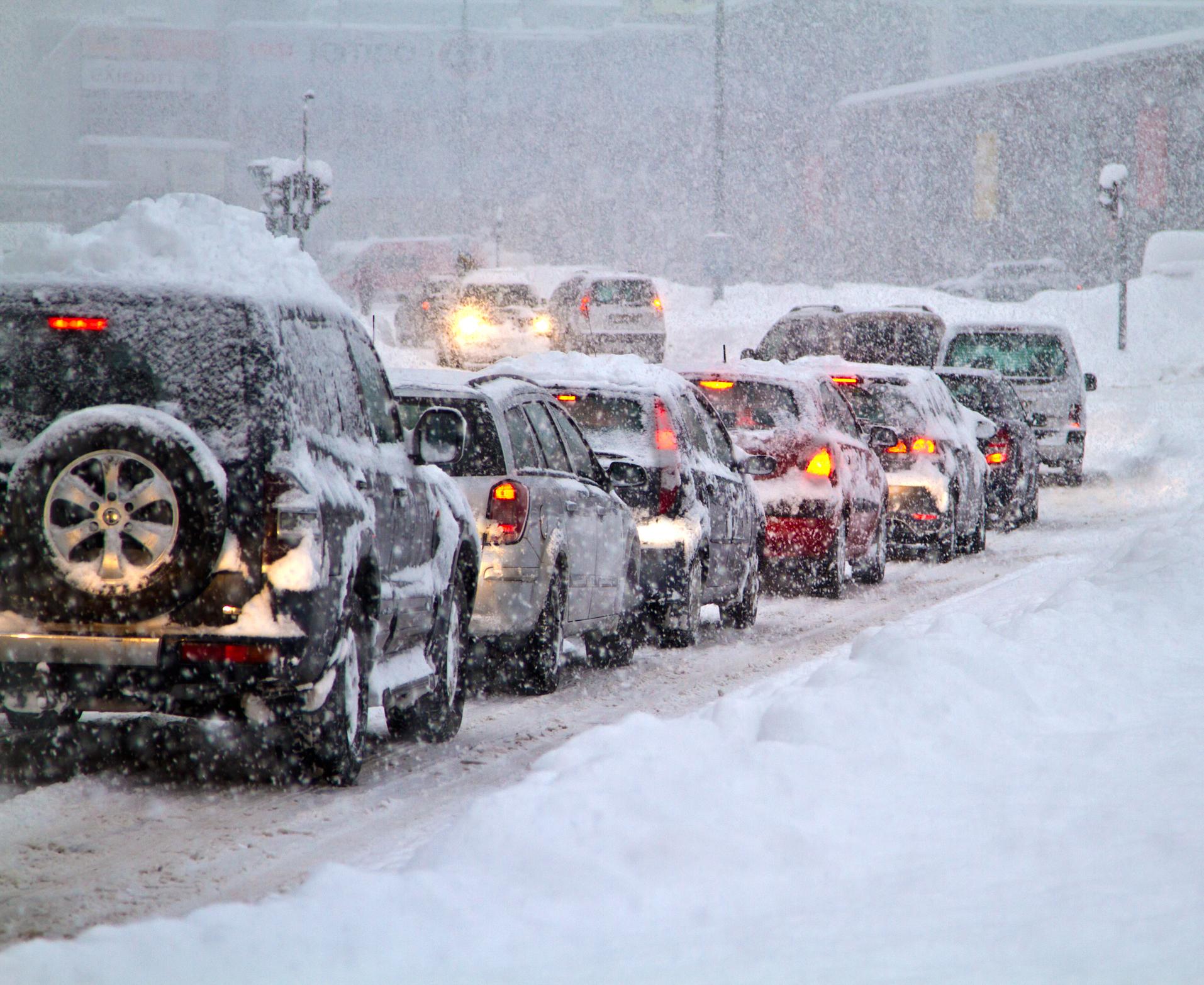 A traffic jam of cars stuck in the snow