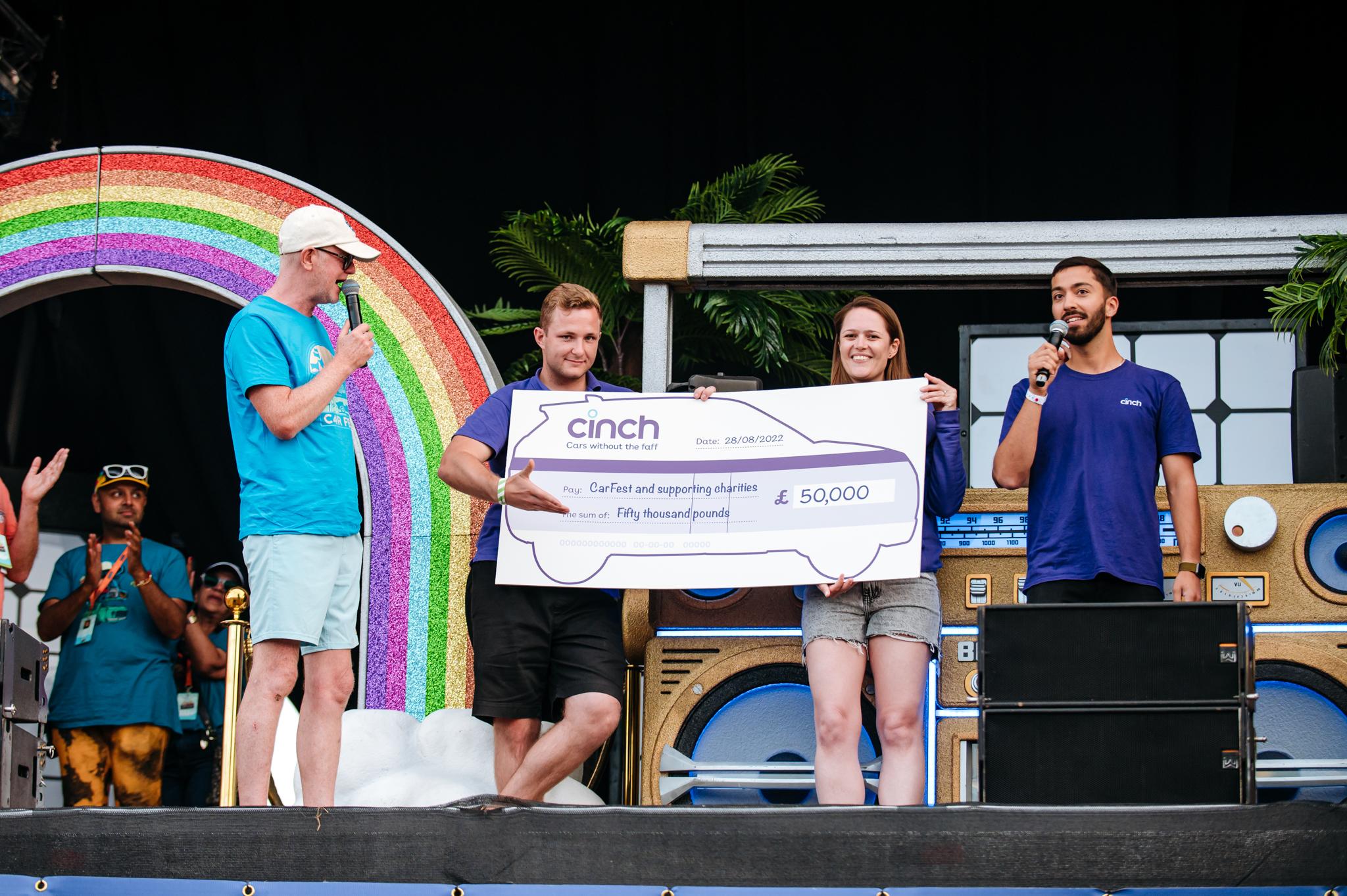 cinch presenting a £50,000 cheque at CarFest 