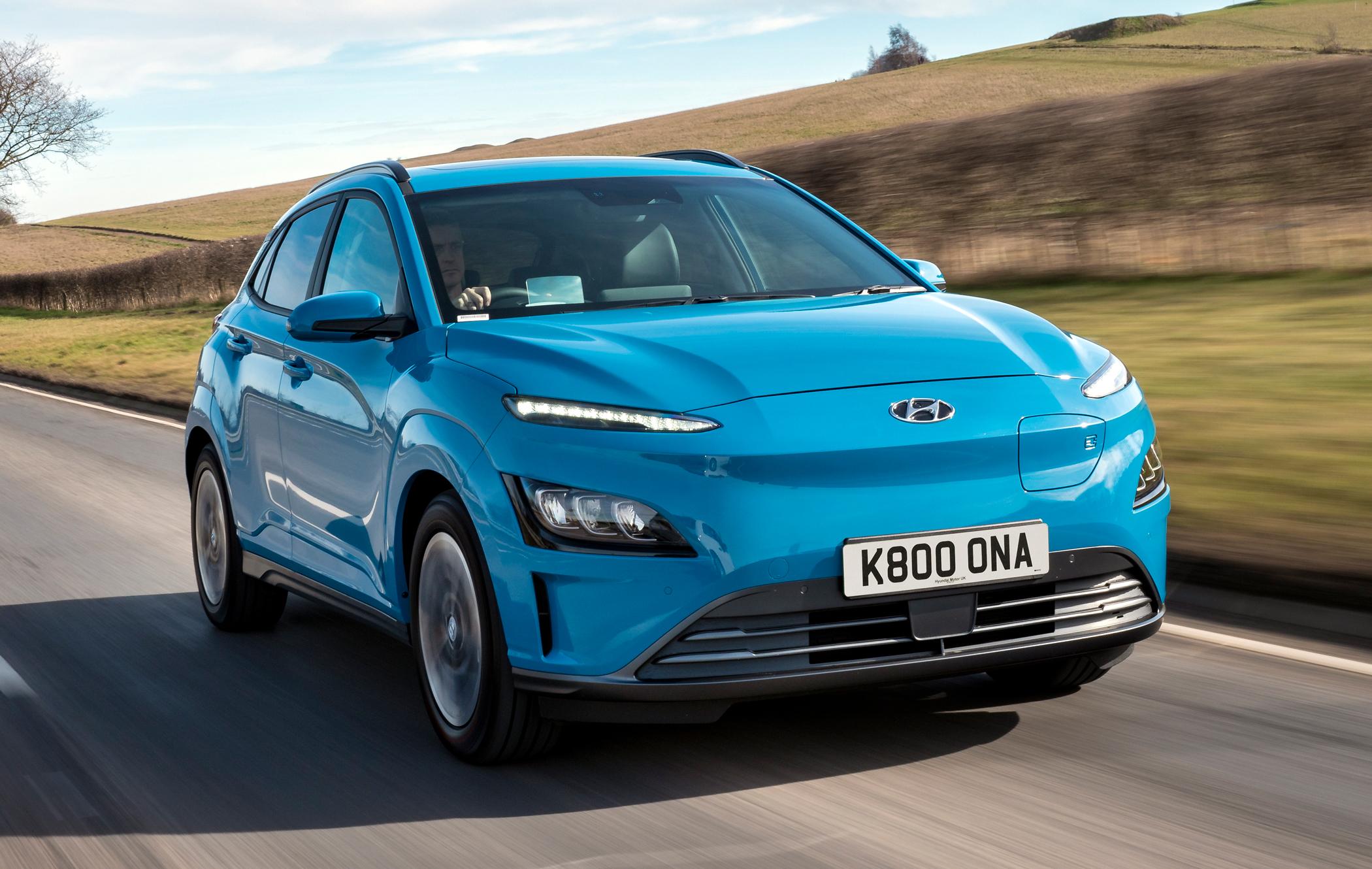 a blue hyundai kona ev driving