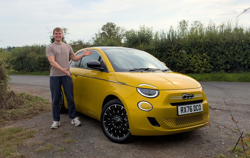 Craig Hale with yellow Fiat 500 Hybrid parked by the roadside, with greenery in the background.