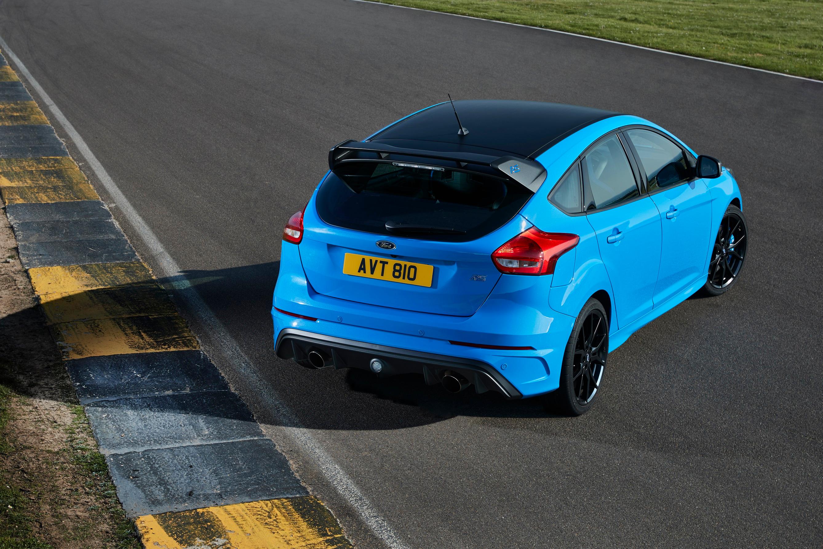 a Nitros Blue Ford Focus RS parked on a race track