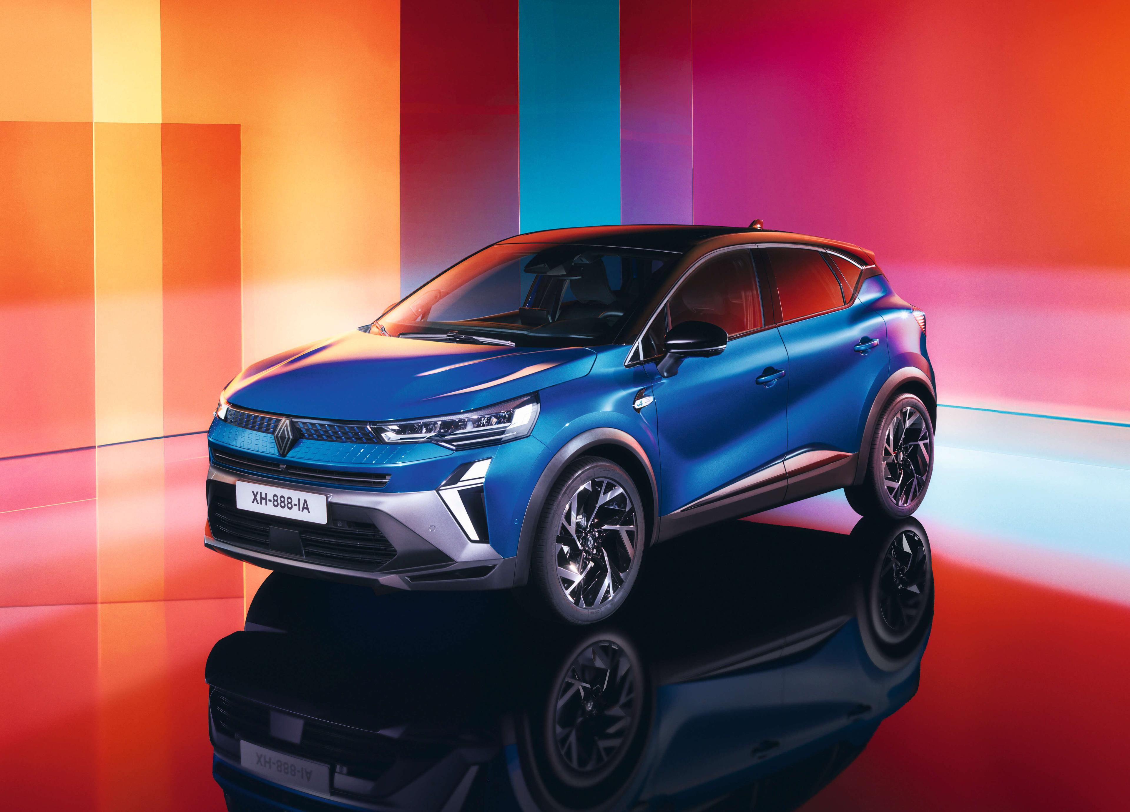 a blue renault captur parked in a studio with red and orange lighting