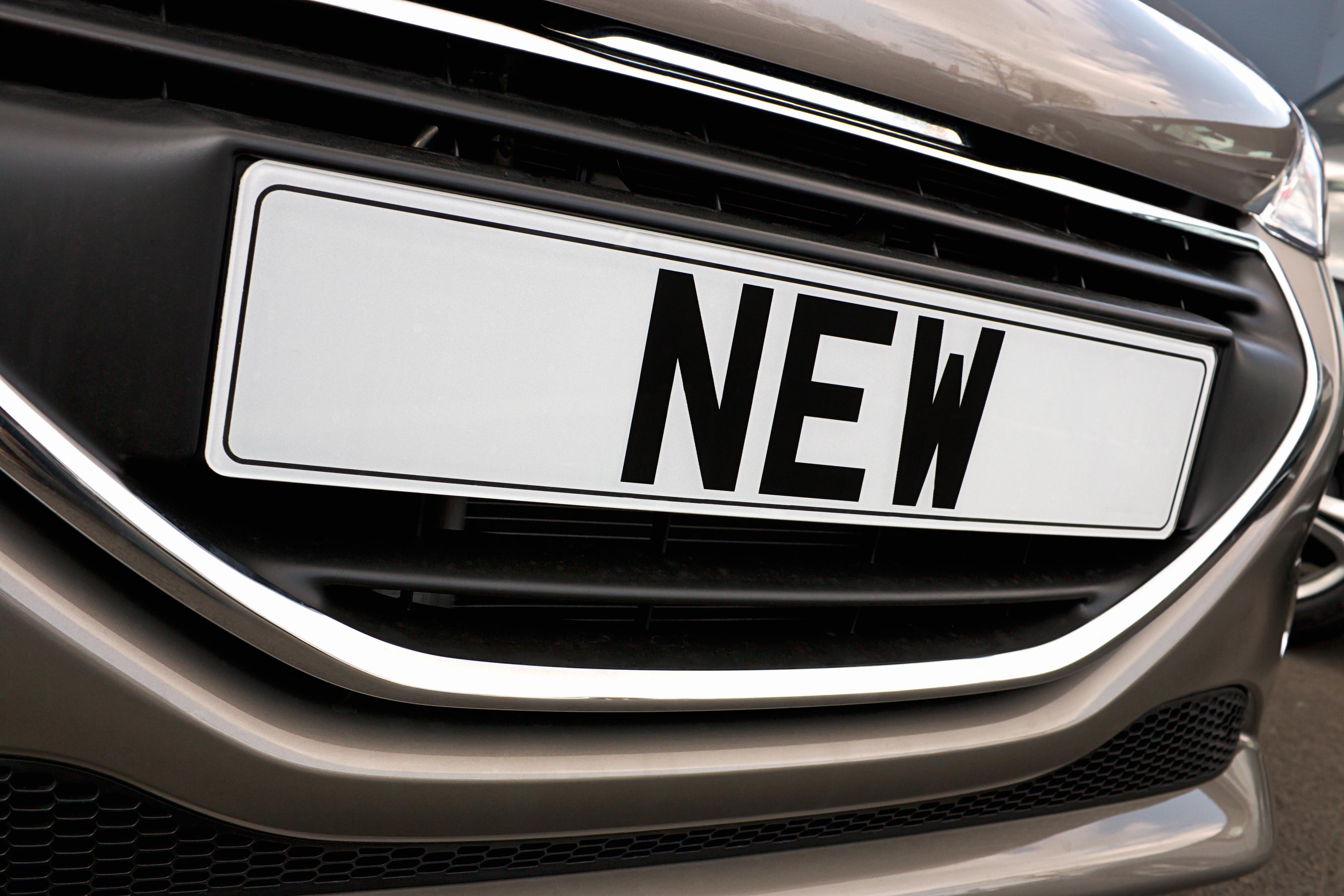 A close up shot of a number plate reading: 'NEW'