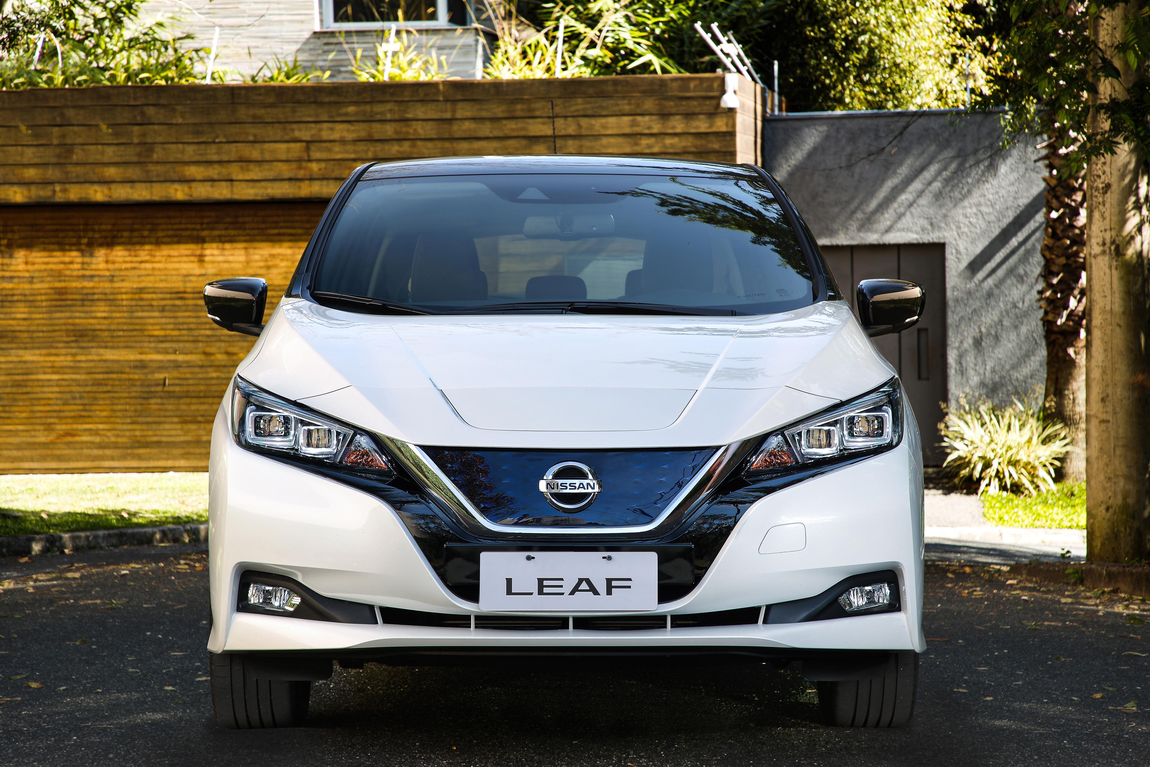 a white Nissan LEAF parked in the shade