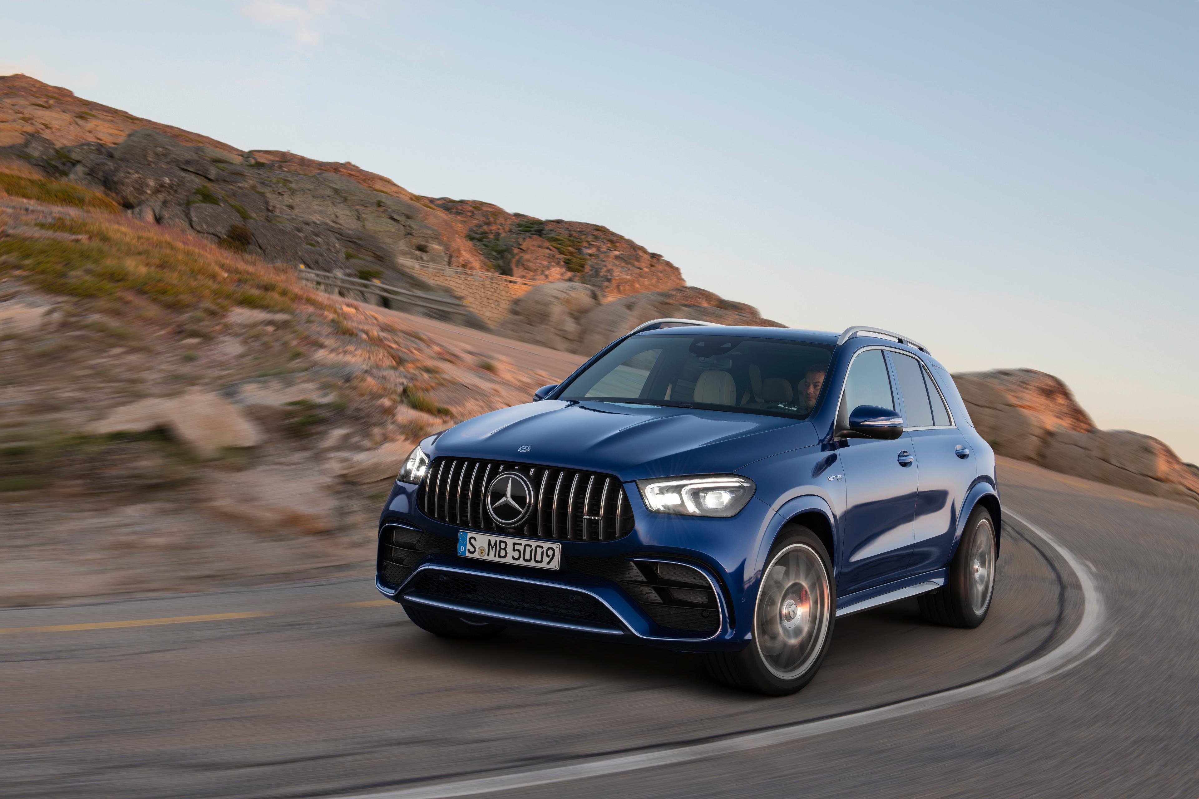 a dark blue Mercedes-AMG GLE 63 driving on a mountain road