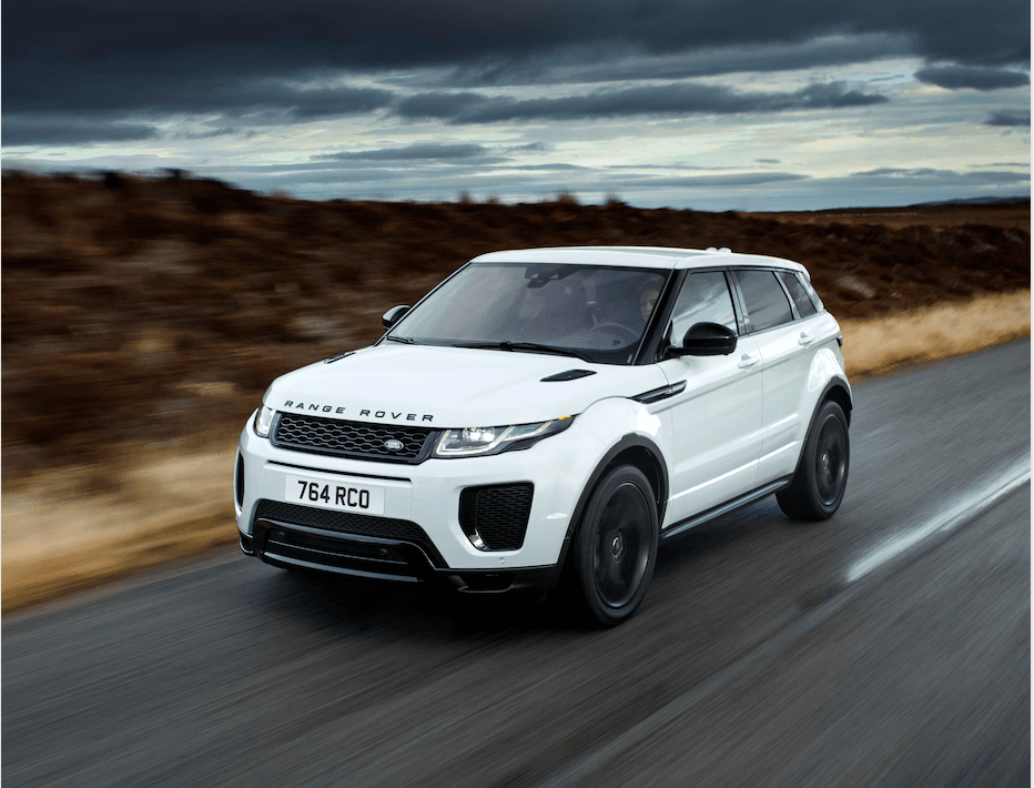 A white Range Rover Evoque driving on an empty road